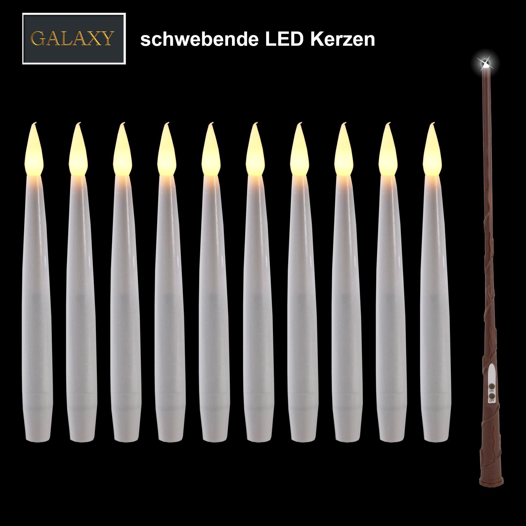 Satz schwebender LED-Kerzen mit Fernbedienungszauberstab, auf schwarzem Hintergrund.