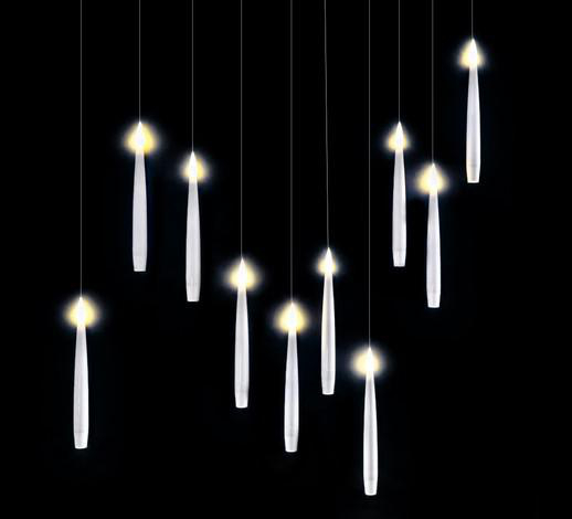 Viele weiße, leuchtende, kerzenartige Lichter vor schwarzem Hintergrund.