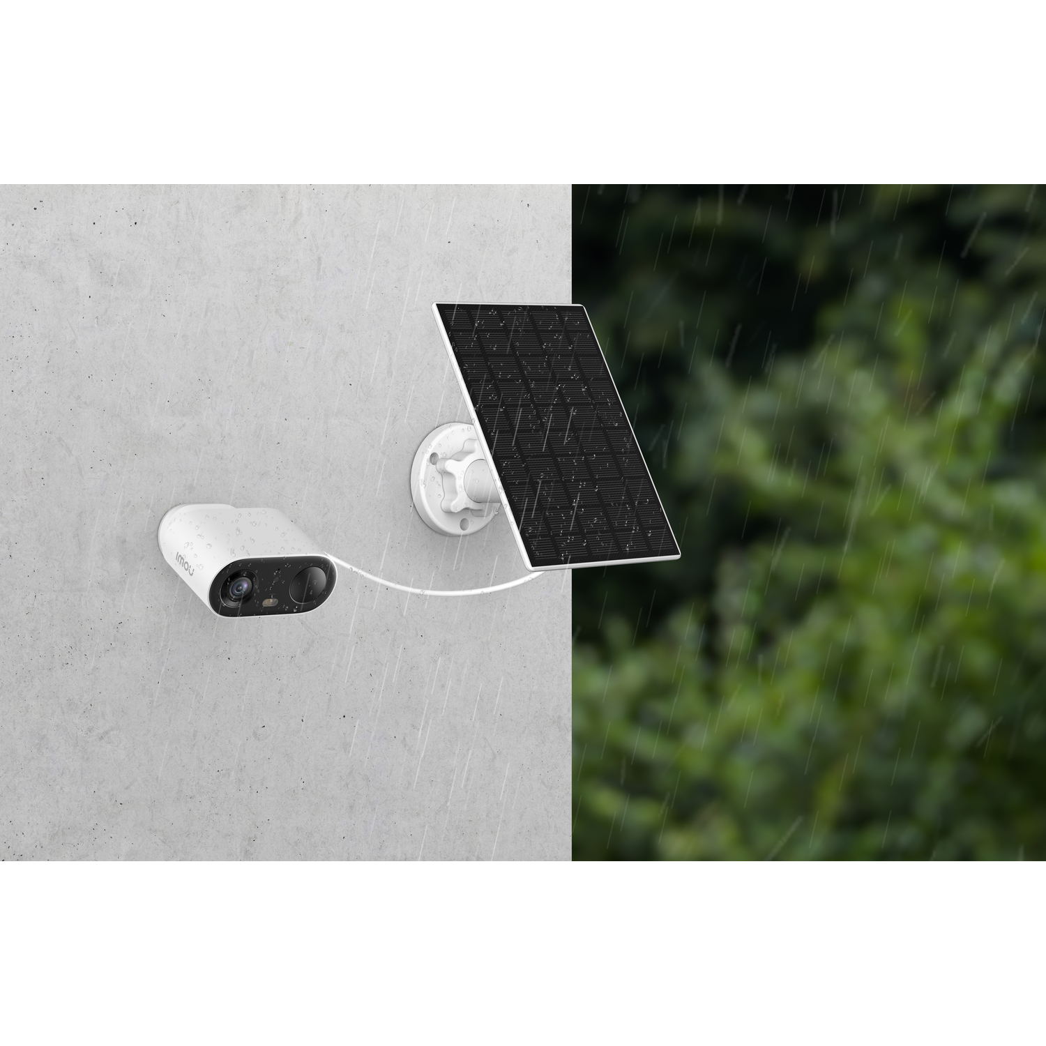 A security camera and solar panel are mounted on a wall. Rain is falling. Green trees are in the background.