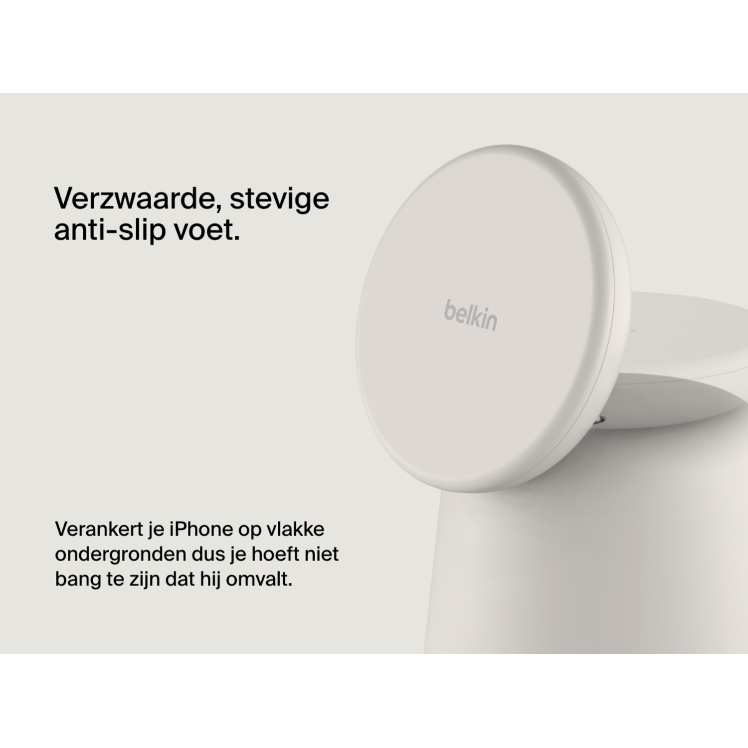 A white Belkin wireless charging stand with a white base and a white disc, with the Belkin logo.