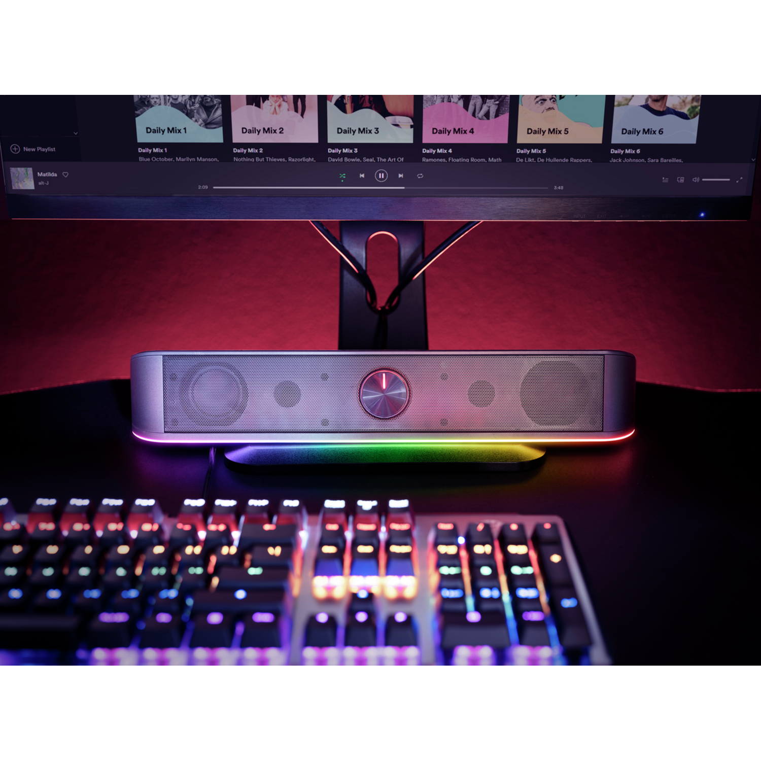 A soundbar with colorful lights and a keyboard below.