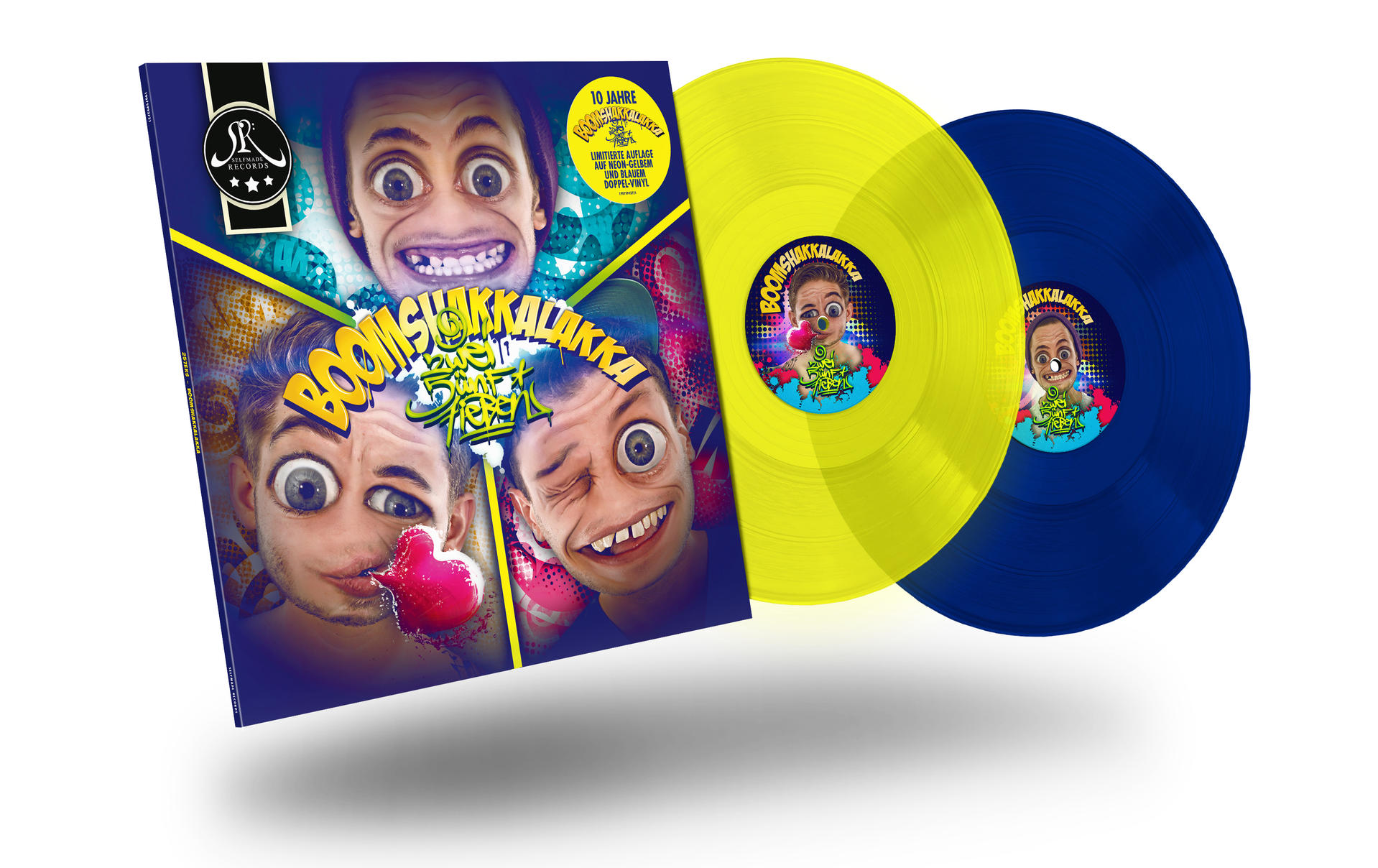 Albumcover mit zwei Cartoon-Gesichtern und dem Schriftzug BOOMSHAKALAKKA. Zwei Vinylplatten sind sichtbar.