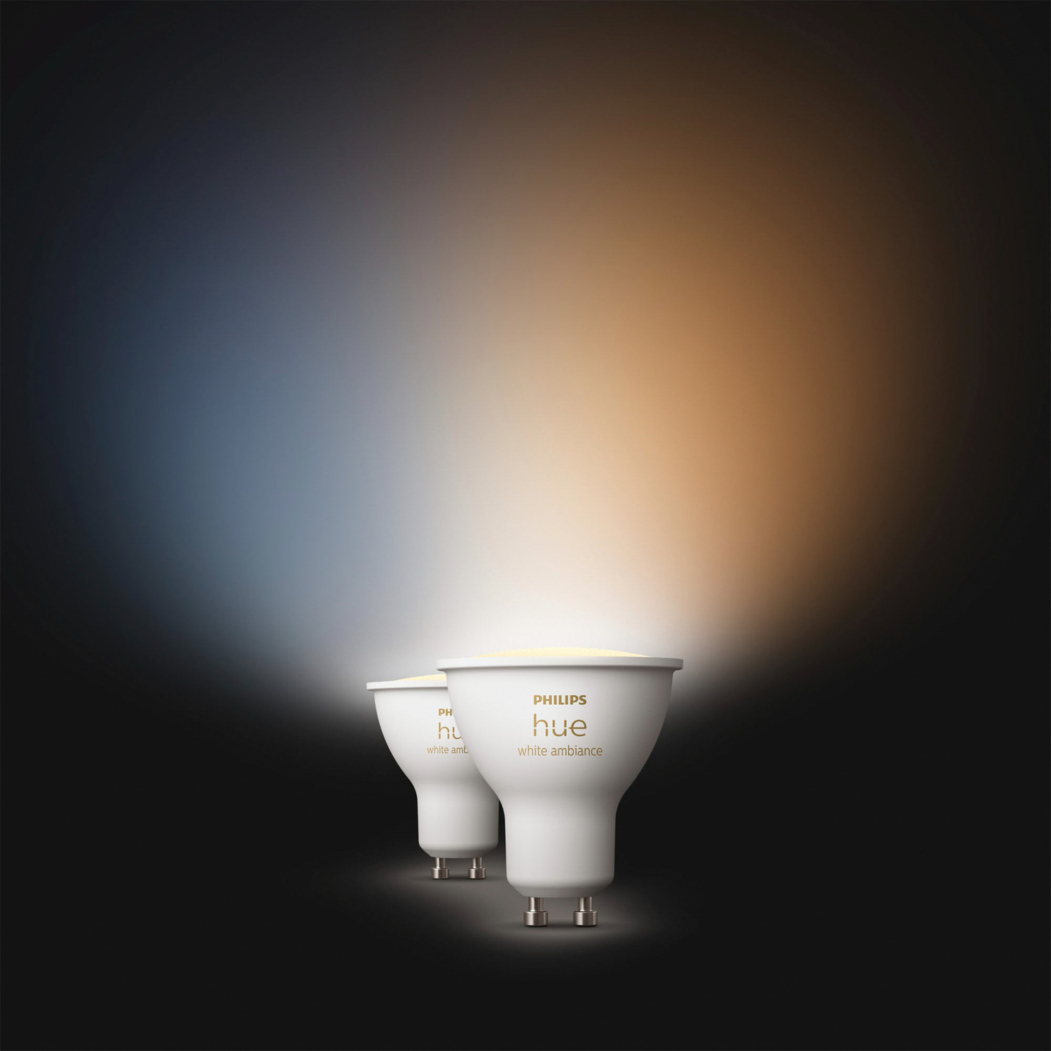 Deux ampoules intelligentes Philips Hue blanches, avec un fond dégradé bleu et orange.