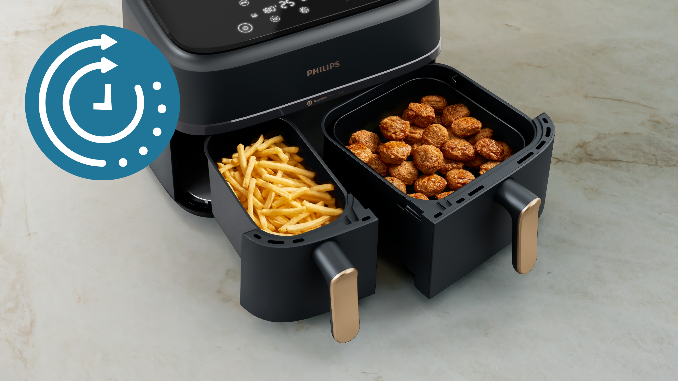 Friggitrice ad aria con due scomparti, uno con patatine fritte e l'altro con polpette.