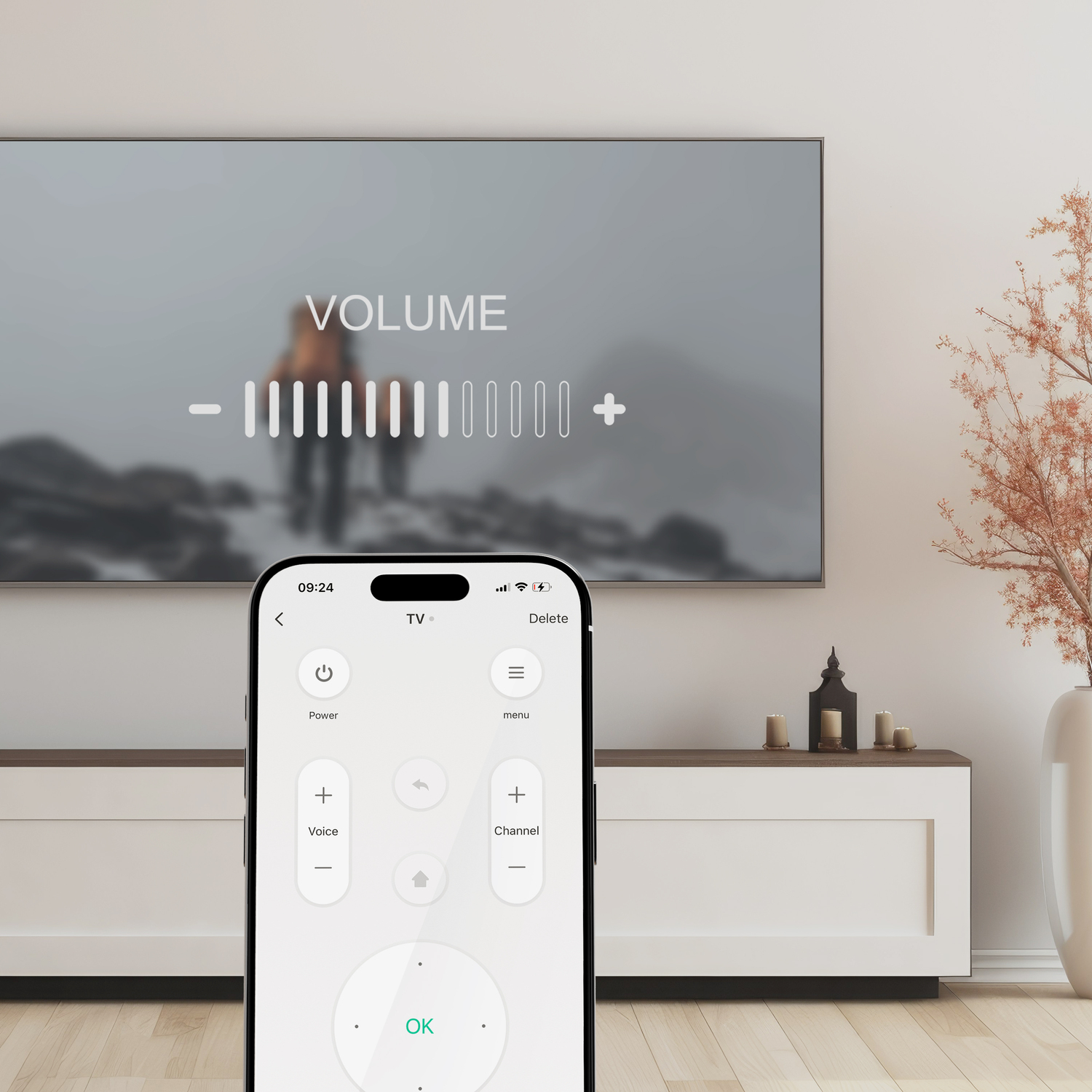 TV screen with volume control, phone with app, white cabinet.