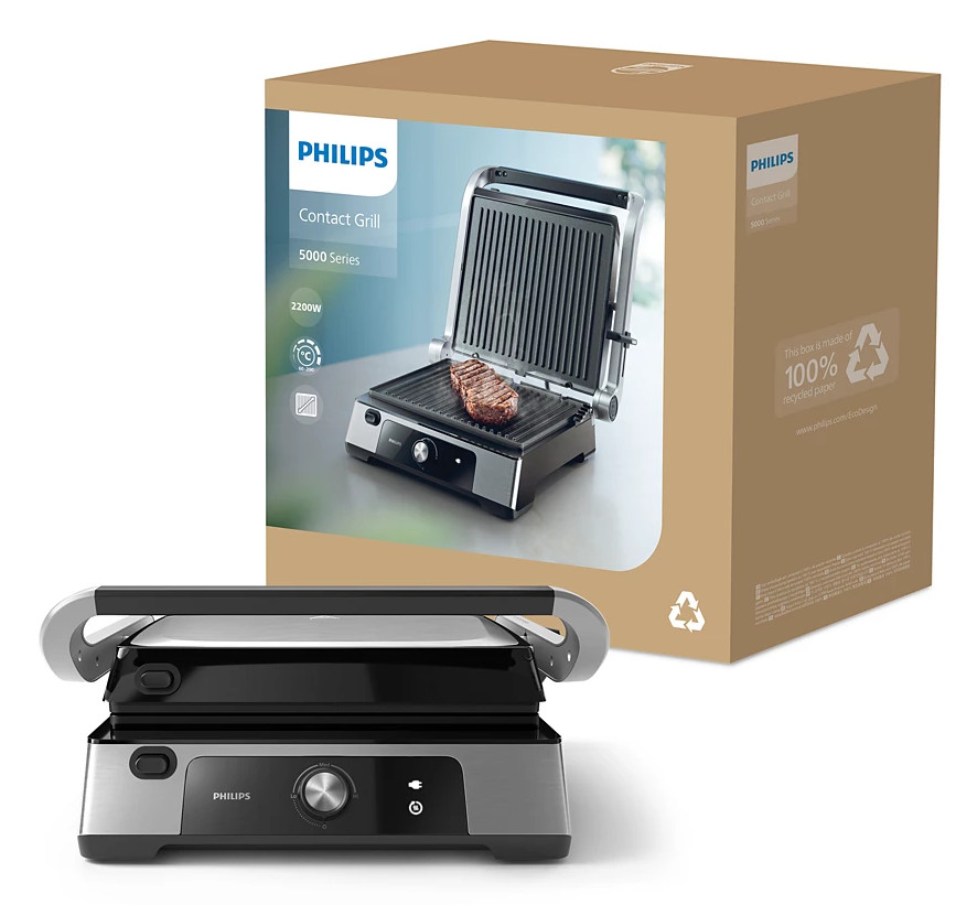 Grill kontaktowy Philips z opakowaniem. Grill z otwartą pokrywą i grillowanym mięsem.