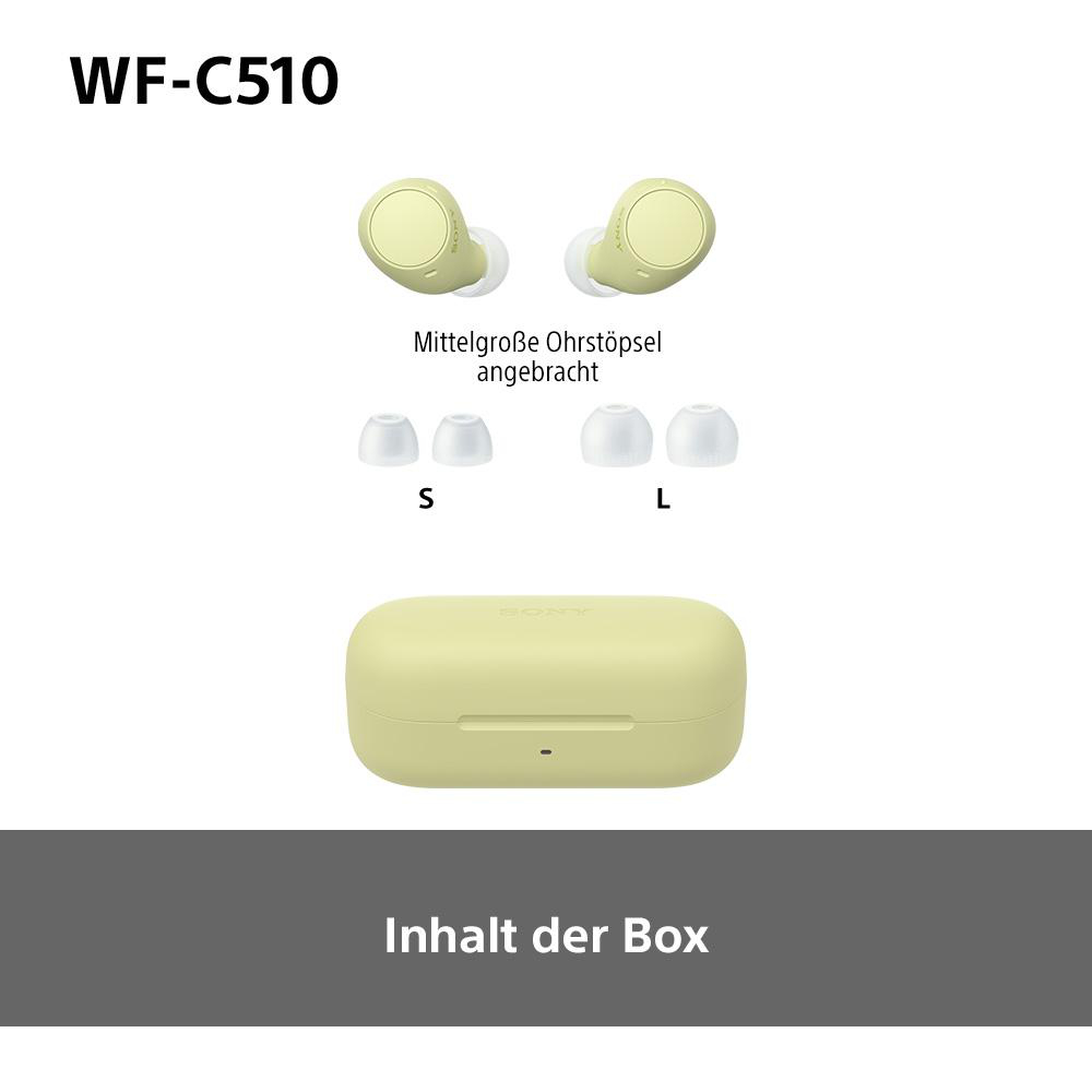 Gelbe Ohrhörer und Ladecase mit zusätzlichen Ohrstöpseln, Text auf Deutsch.