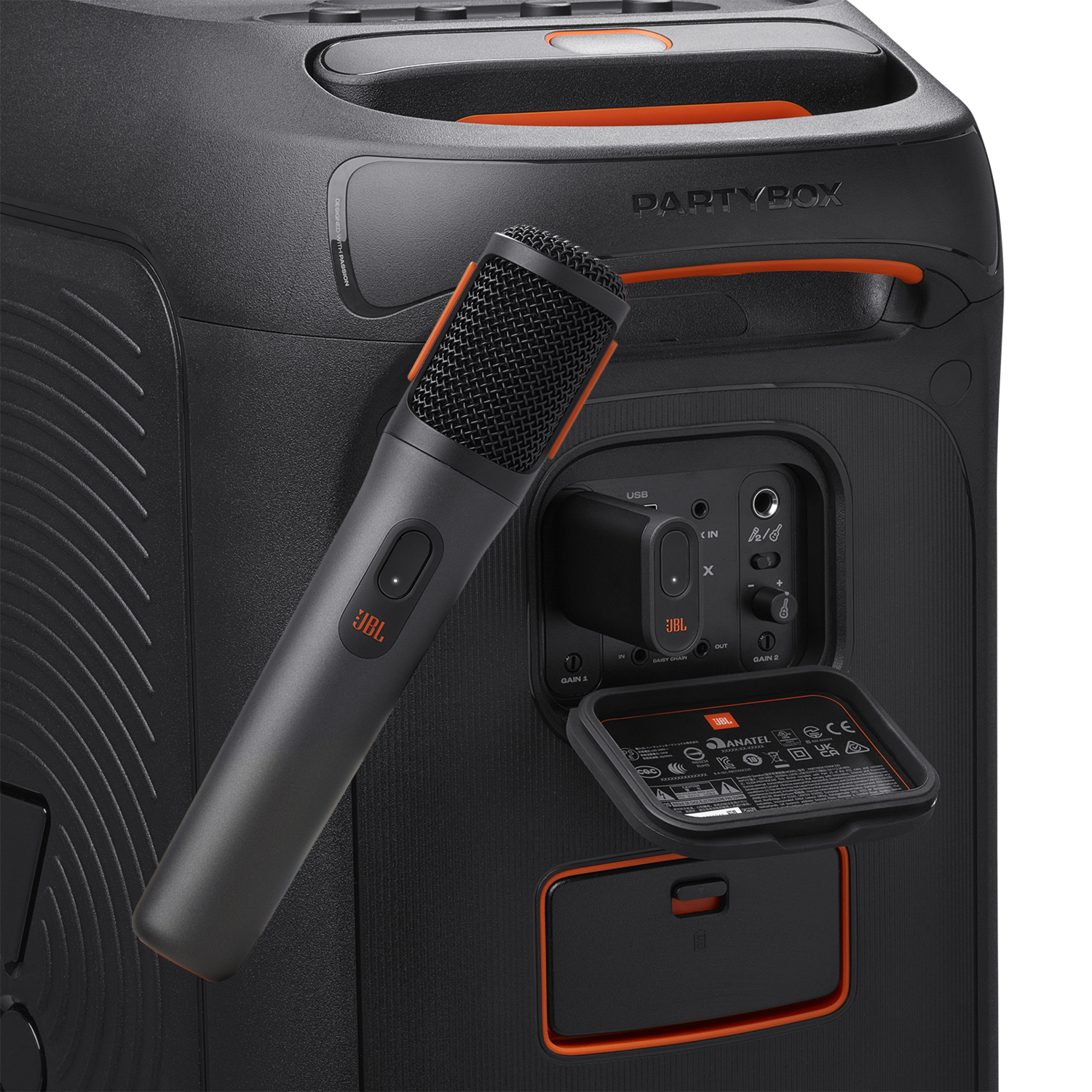 A black JBL PartyBox speaker with an attached microphone and an open panel showing inputs.