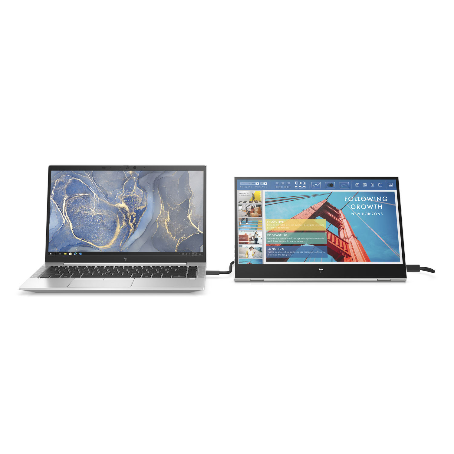 Laptop next to a monitor showing a webpage with a city bridge.