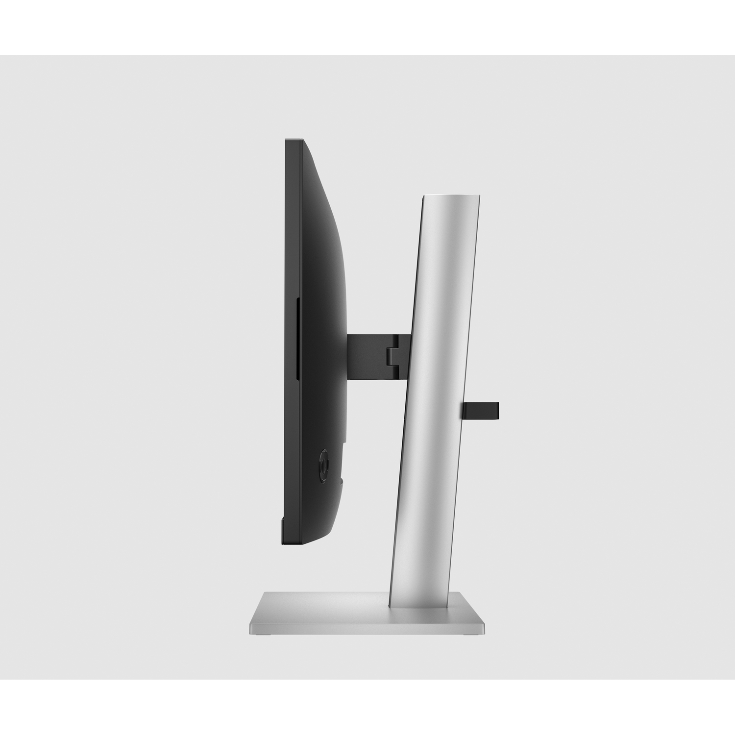 Zijaanzicht van een moderne computermonitor, met een metalen standaard, op een lichte achtergrond.