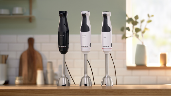 Farklı renklerde üç Bosch el blenderi, siyah, beyaz ve beyaz.
