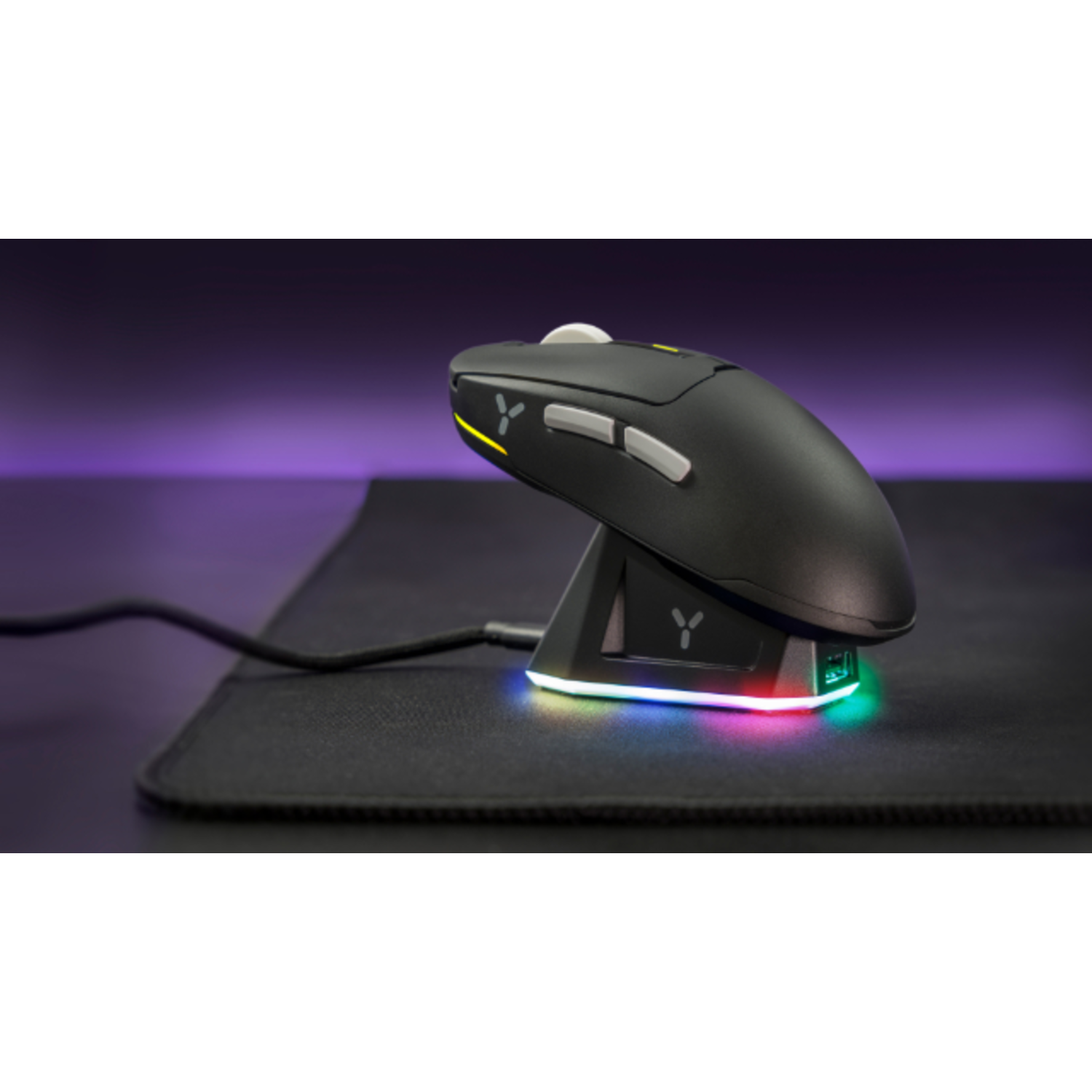 A black gaming mouse on its charging base, with a purple and yellow background.