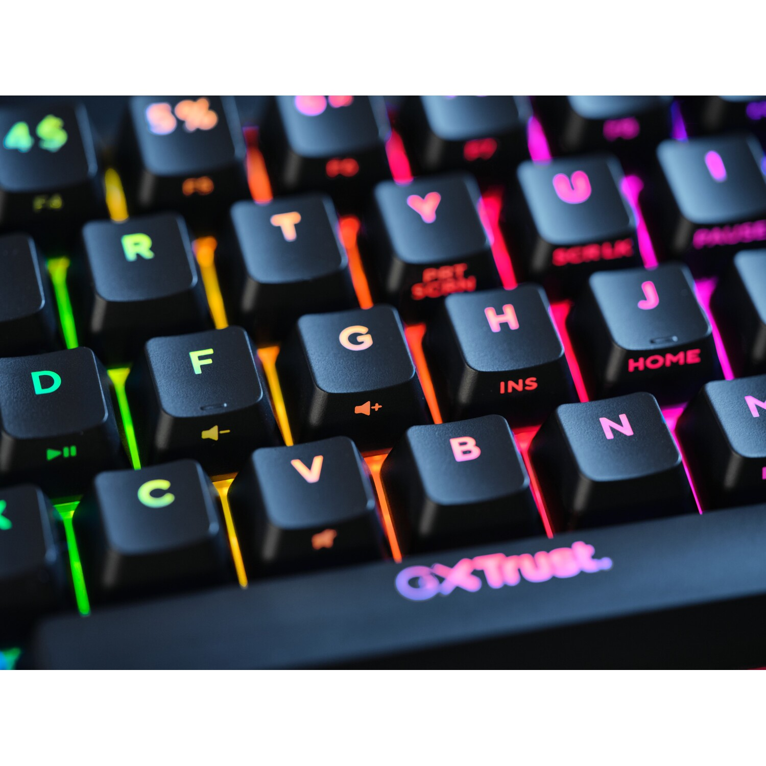Close-up of a keyboard with illuminated keys. The keys are black, and the lights are various colors.