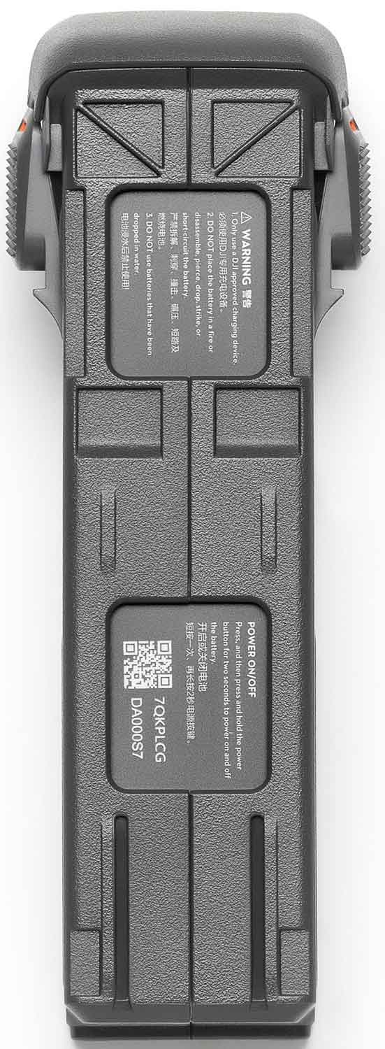 Dark gray drone battery with warning labels and a power on/off button.