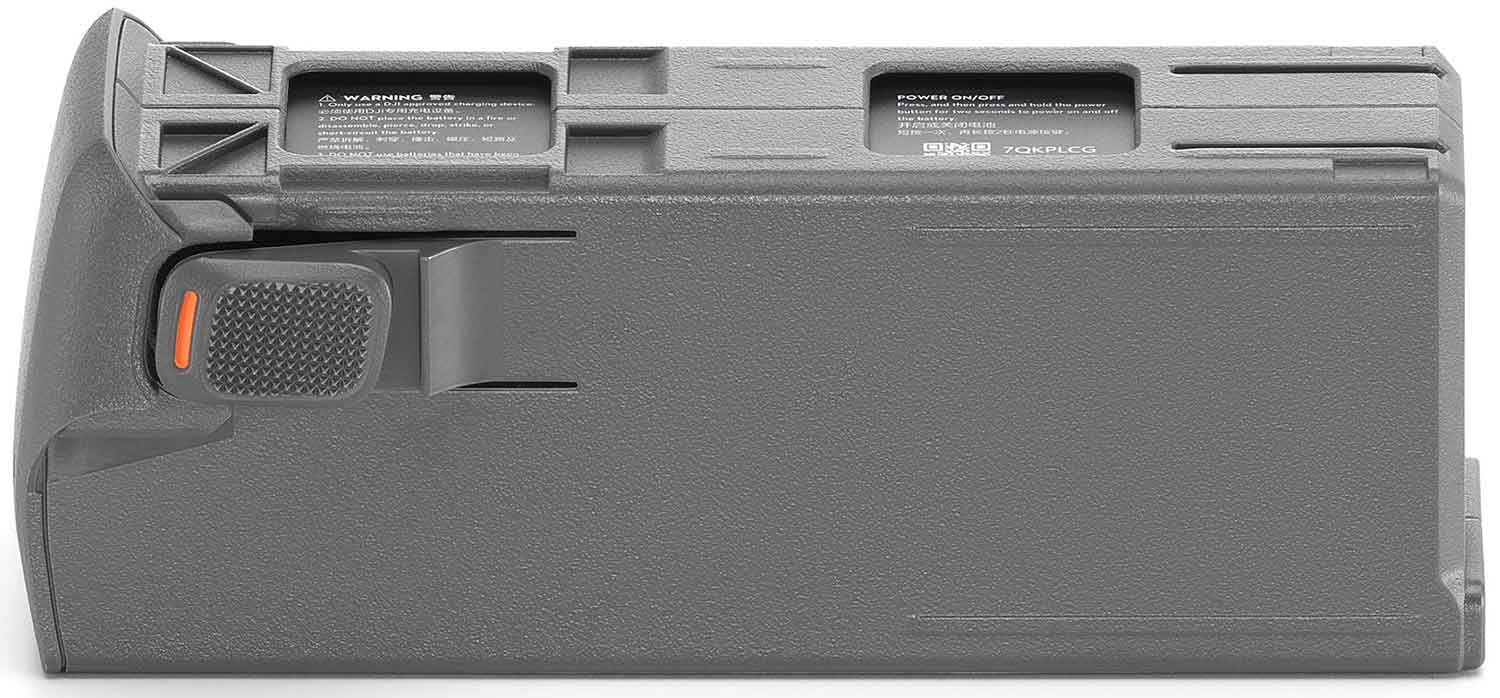 A gray battery pack for a device, featuring a power button and warning labels.