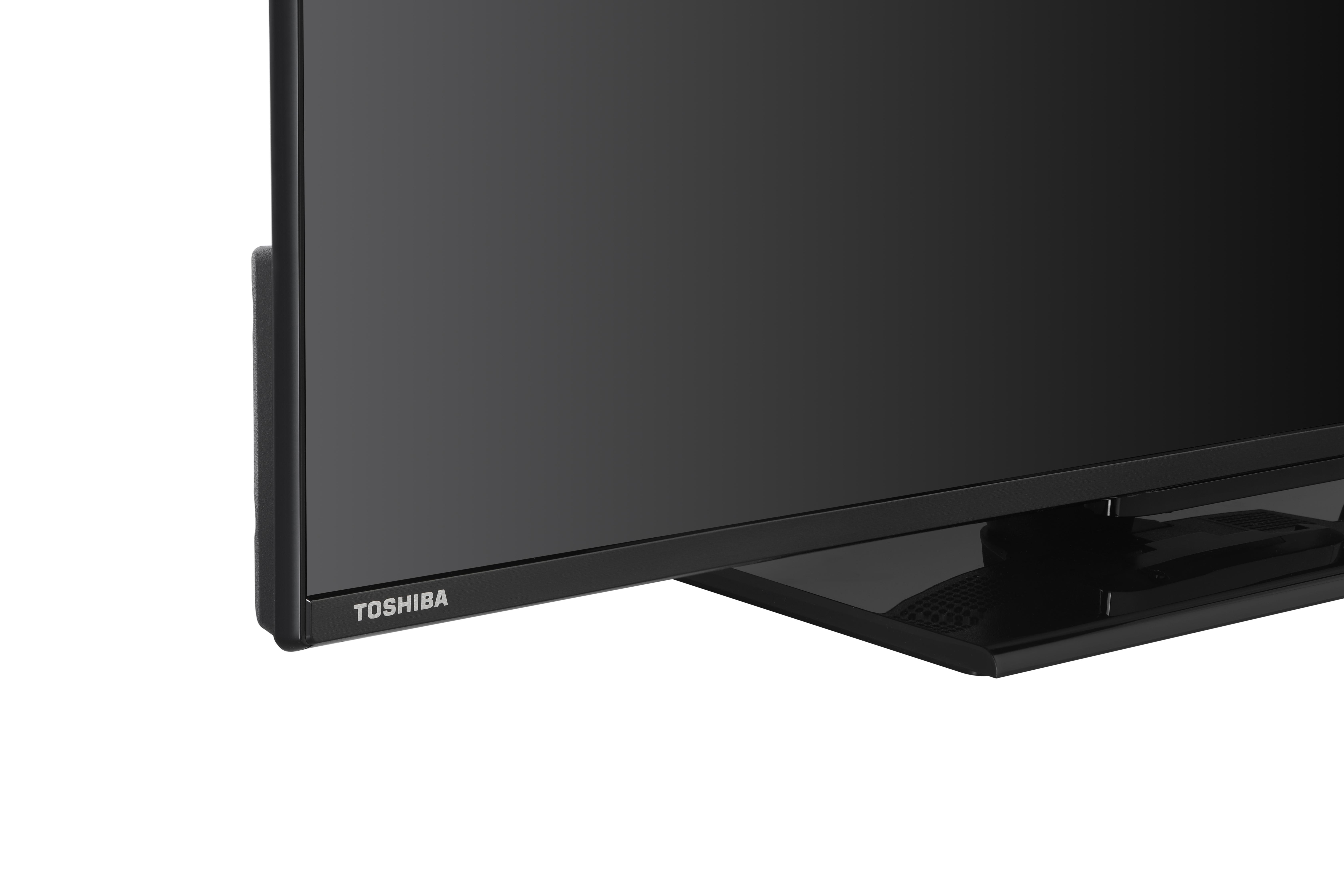 Schwarze Toshiba TV-Ecke, Logo sichtbar. Weißer Hintergrund.