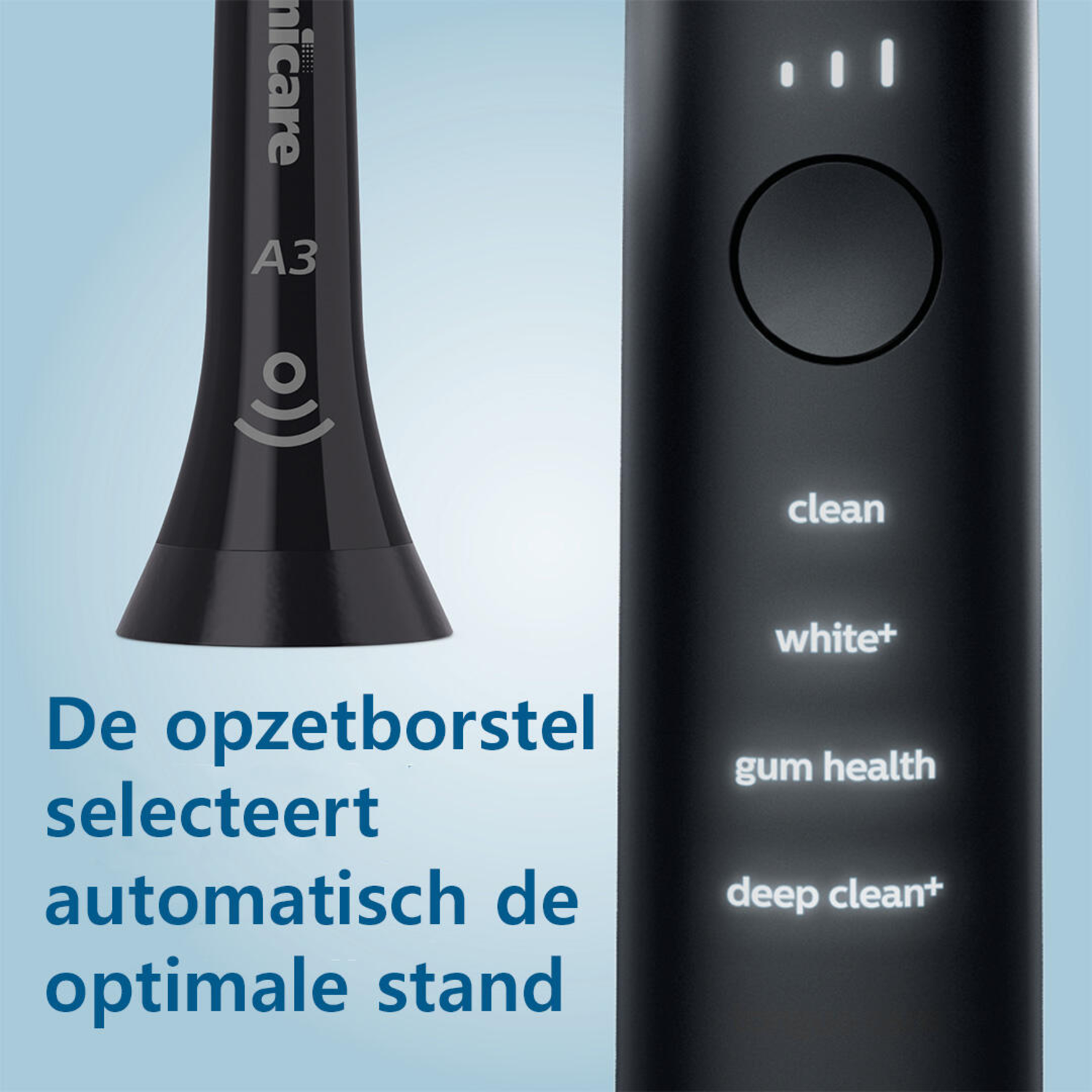 Black electric toothbrush with mode indicators and text, close up.