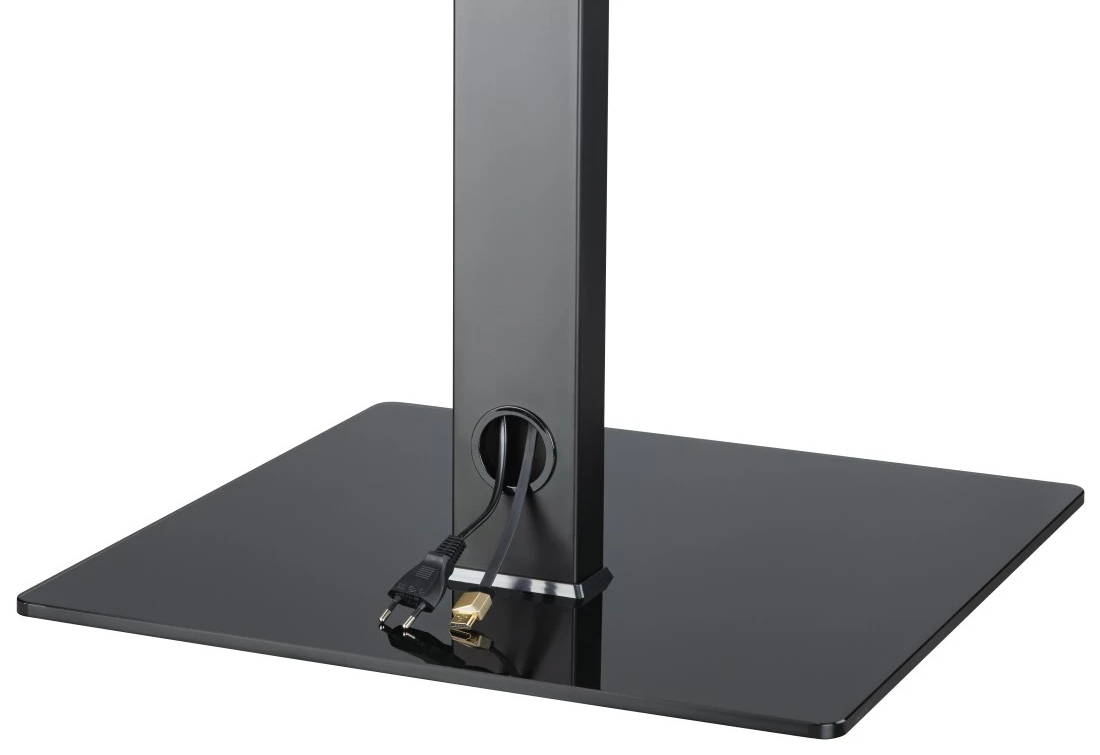 Fekete TV-állvány alap kábelfedővel és táp/HDMI kábelekkel.