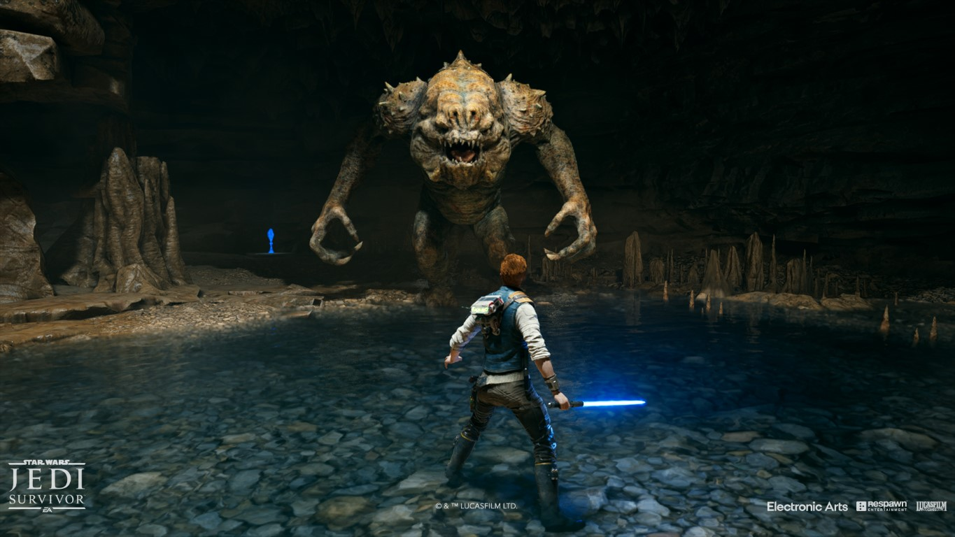 Postać Jedi naprzeciw potworowi w jaskini, z wodą i skałami.