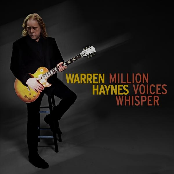 Albumcover mit Warren Haynes, der Gitarre spielt, Text 'Warren Haynes Voices Whisper'.