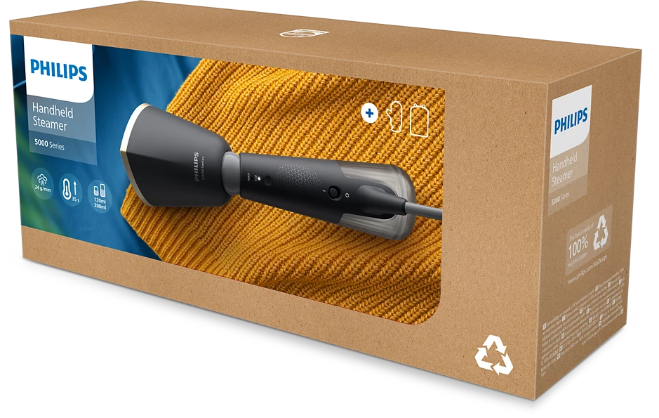 Egy fekete-szürke Philips kézi gőzölő a kartondobozában, sárga pulóveren bemutatva.