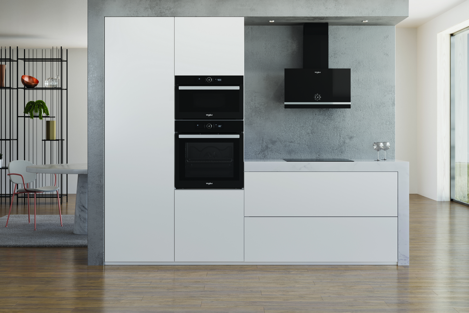 Una cocina moderna con hornos empotrados, una campana extractora y armarios blancos.