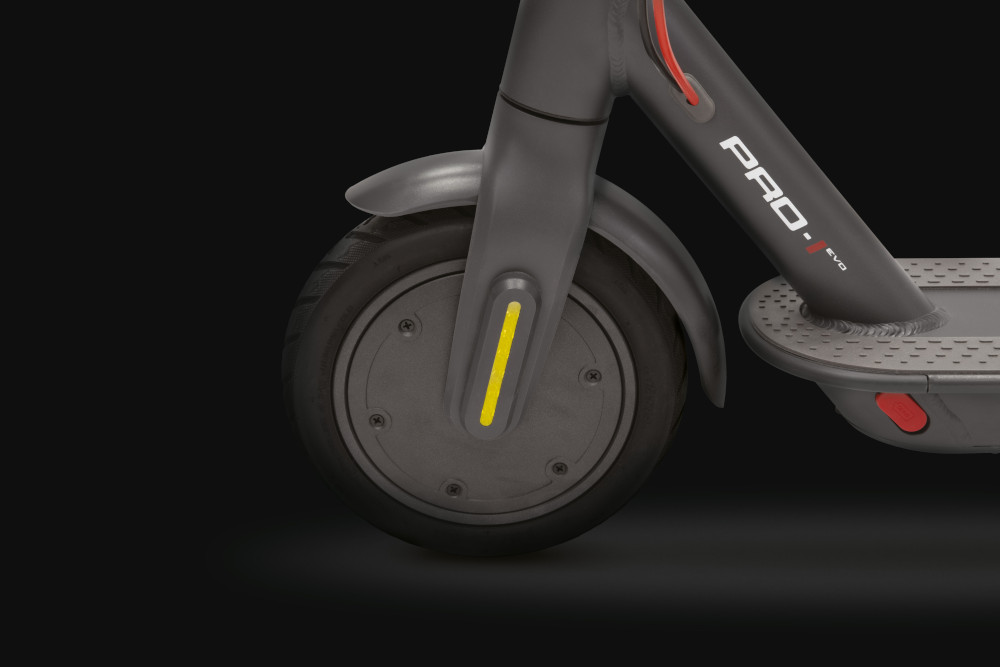 Close-up of an e-scooter wheel and fender. The wheel is black with a yellow accent.