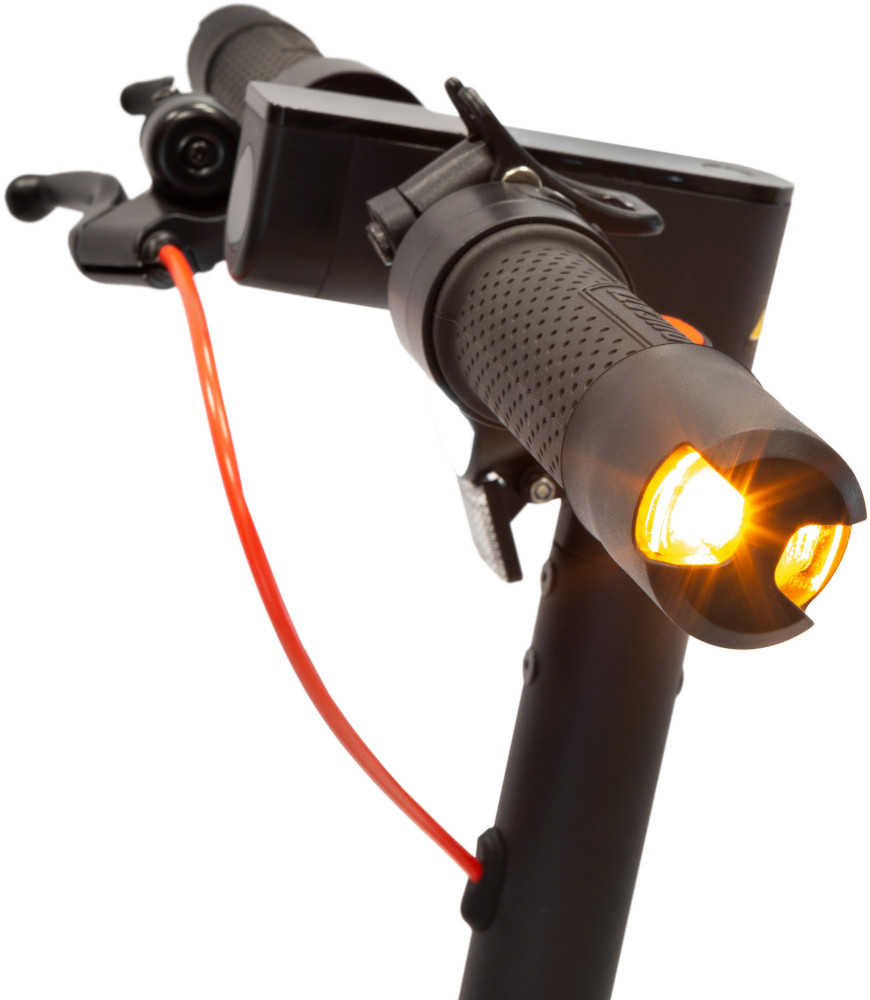 Close-up of a black electric scooter handlebar. The headlight is on.