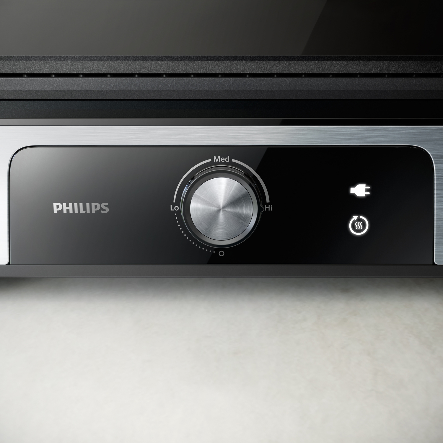 Close-up van een Philips grill bedieningspaneel met een draaiknop en stroomindicator.