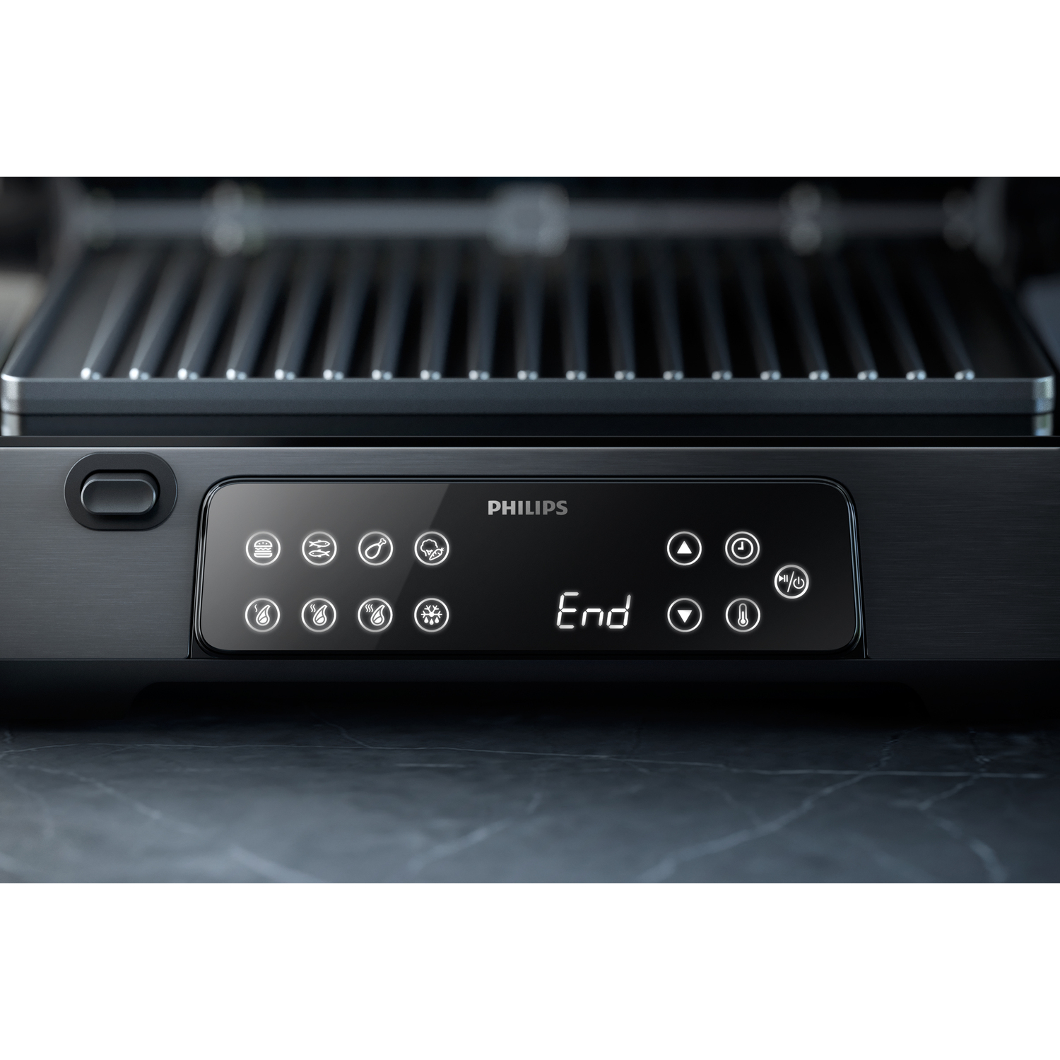 Gros plan sur le panneau de commande noir du grill Philips. Il comporte des boutons et un écran numérique.