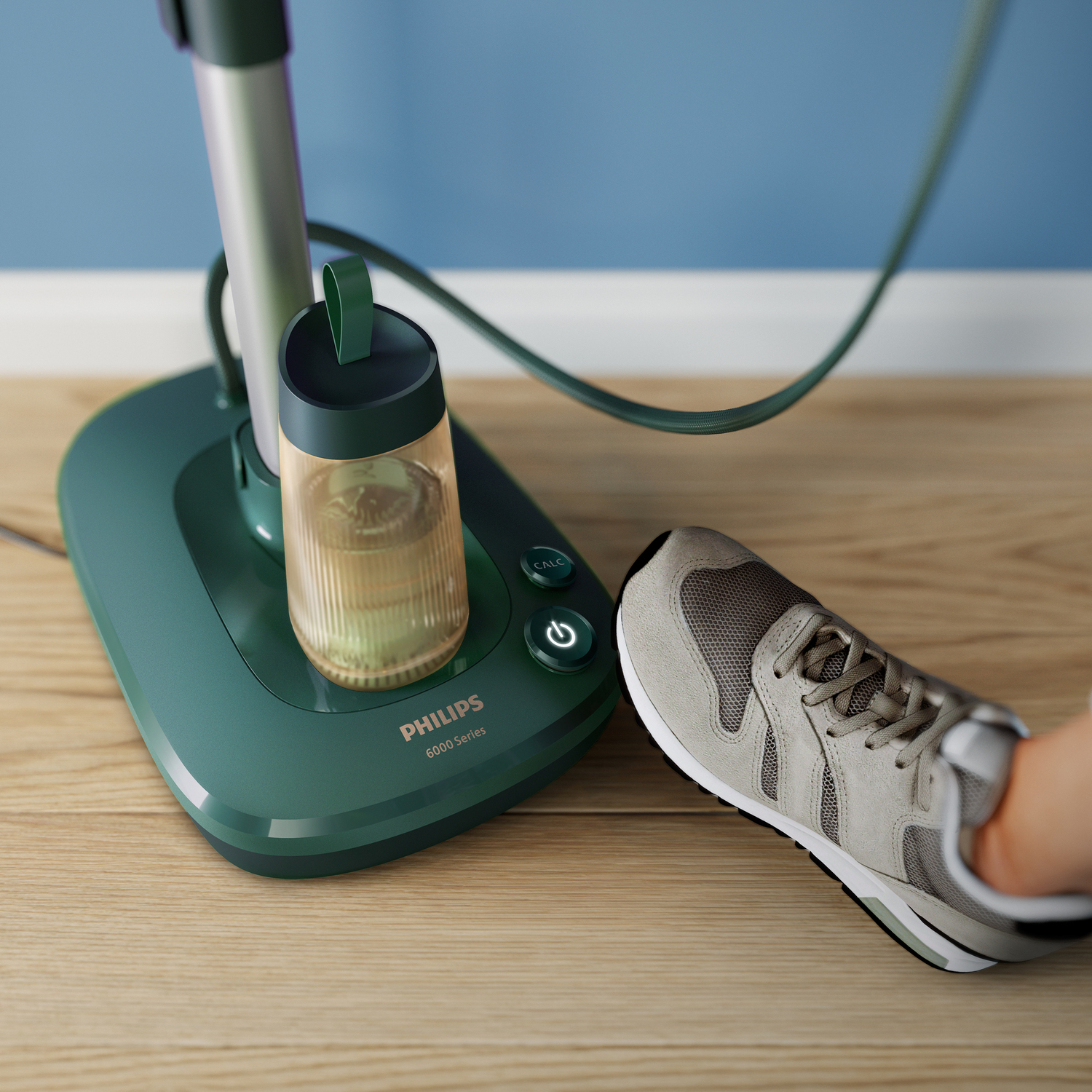Un balai vapeur Philips série 6000 vert et blanc avec une chaussure.