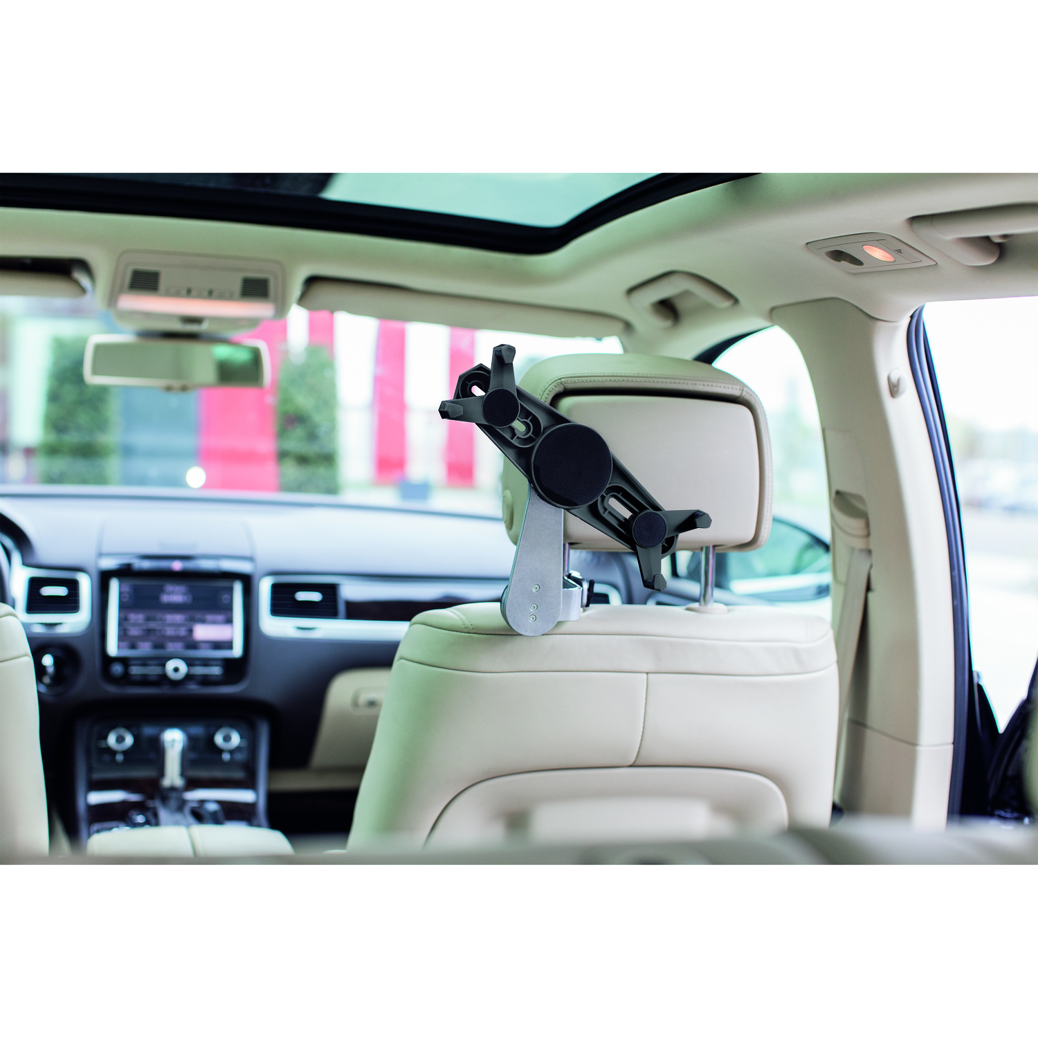 A tablet holder is installed in a car. It's attached to the headrest.