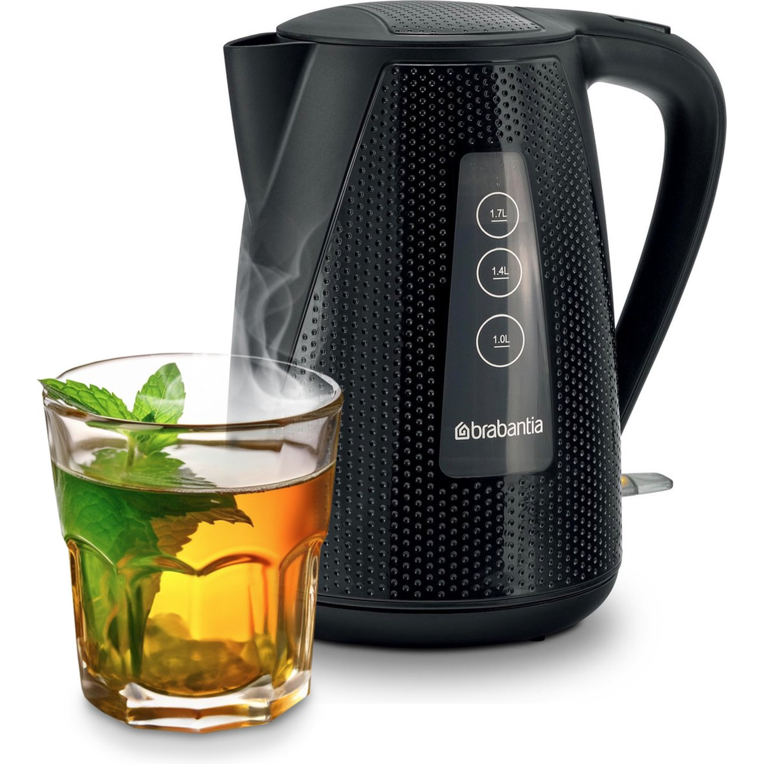 Black electric kettle with a glass of tea and mint leaves, steam rising.