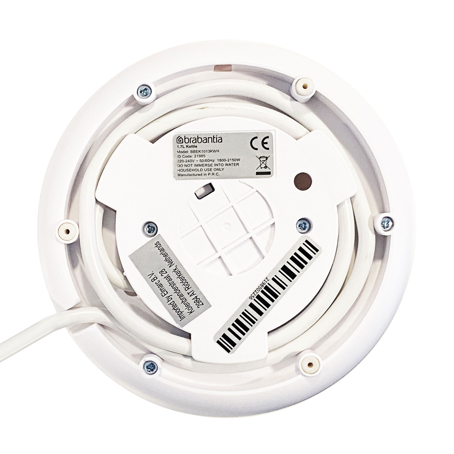 White kettle with the bottom facing up. Screws and a label are visible.