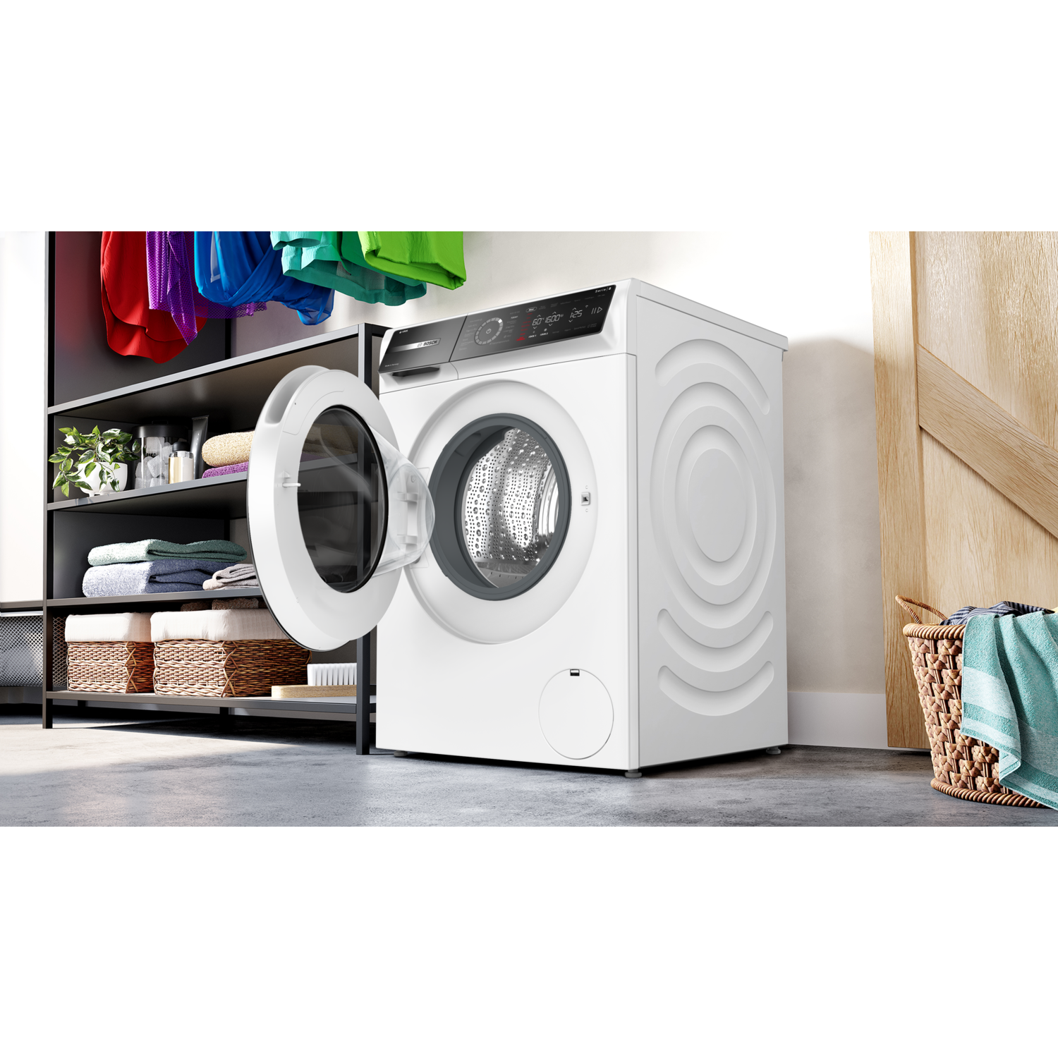 White washing machine with open door next to laundry items.