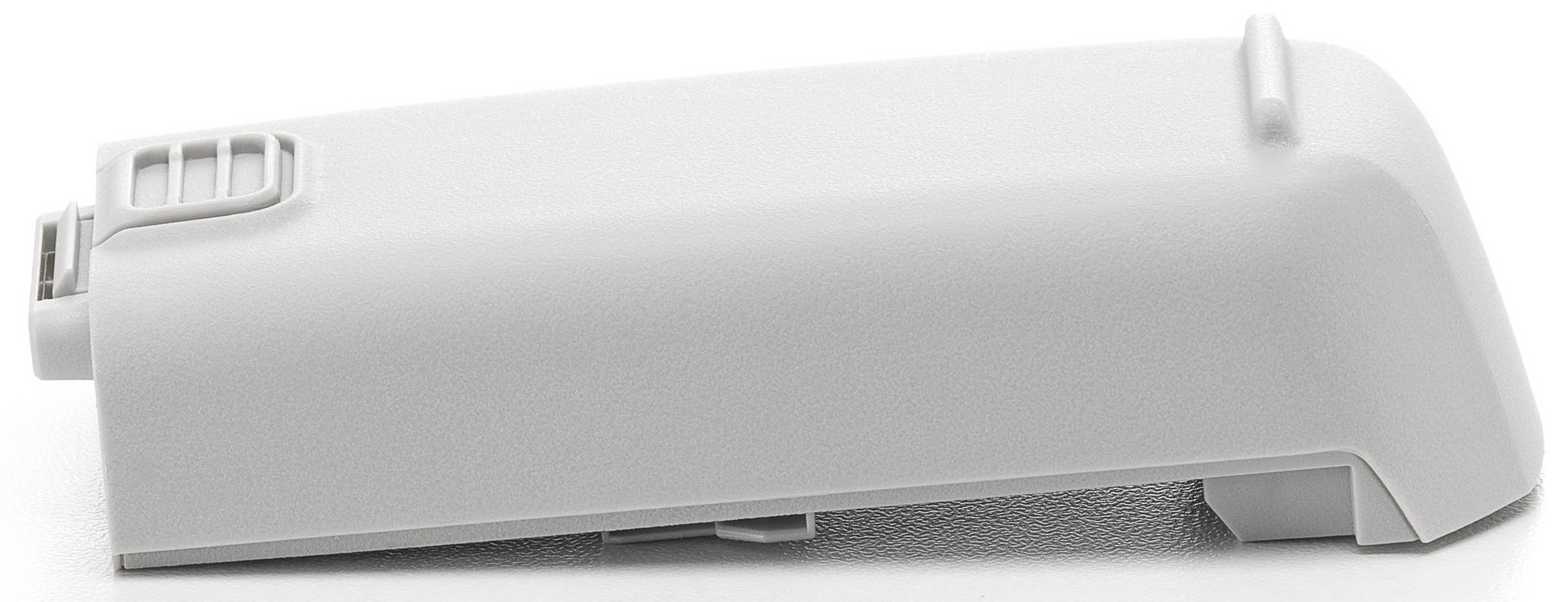 Biały akumulator, leżący poziomo, z bocznym przyciskiem i portem.