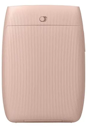 Un appareil rose cylindrique avec une texture côtelée verticale. Il a un petit interrupteur en haut. Le design est simple et moderne.