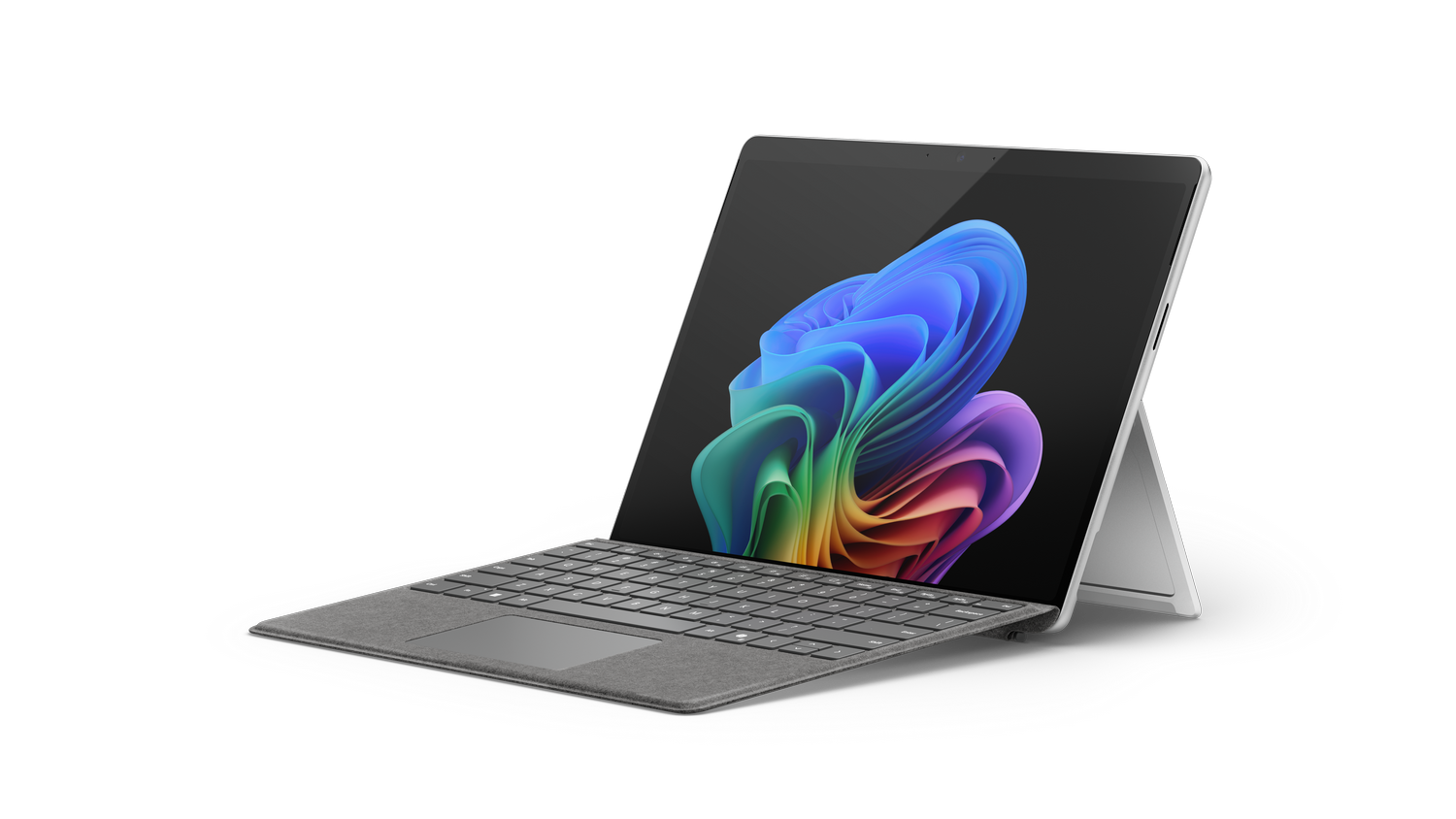 Una tableta Microsoft Surface plateada abierta con un teclado, mostrando una pantalla colorida sobre un fondo negro.
