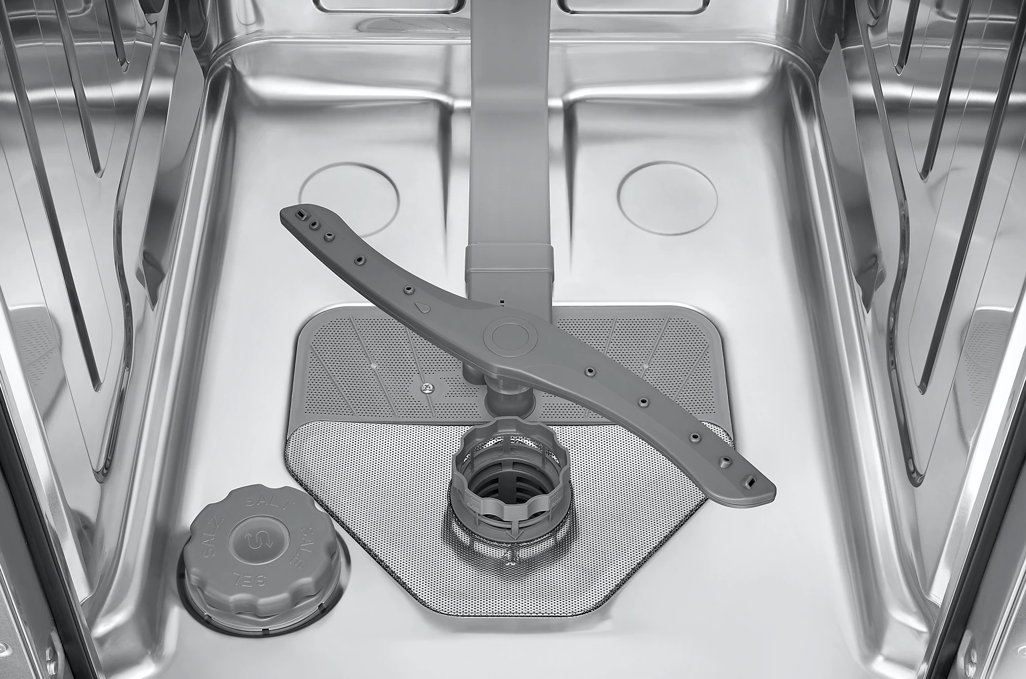Wnętrze zmywarki, pokazujące ramiona natryskowe i filtr.