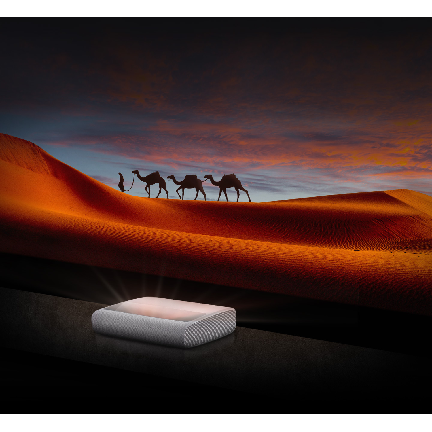 Un projecteur projette de la lumière sur une surface sombre, avec des chameaux marchant sur des dunes de sable en arrière-plan.