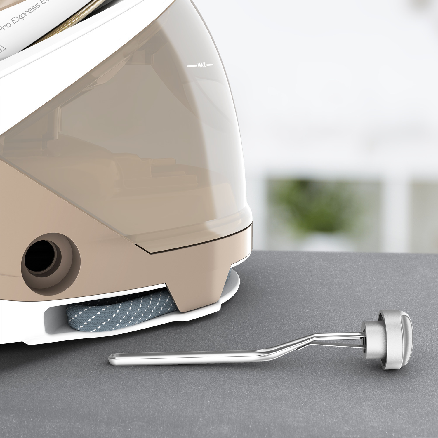 Close-up of a steam iron with a water tank and a detached heating element.