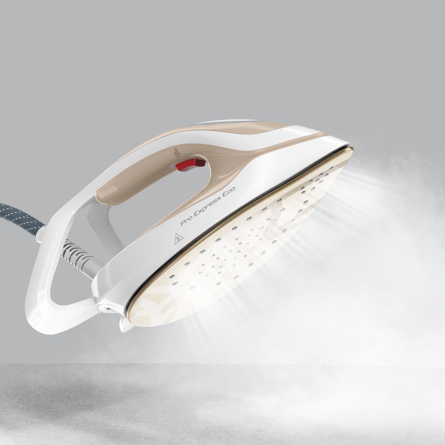A white and beige iron emits steam. The iron is angled upwards.