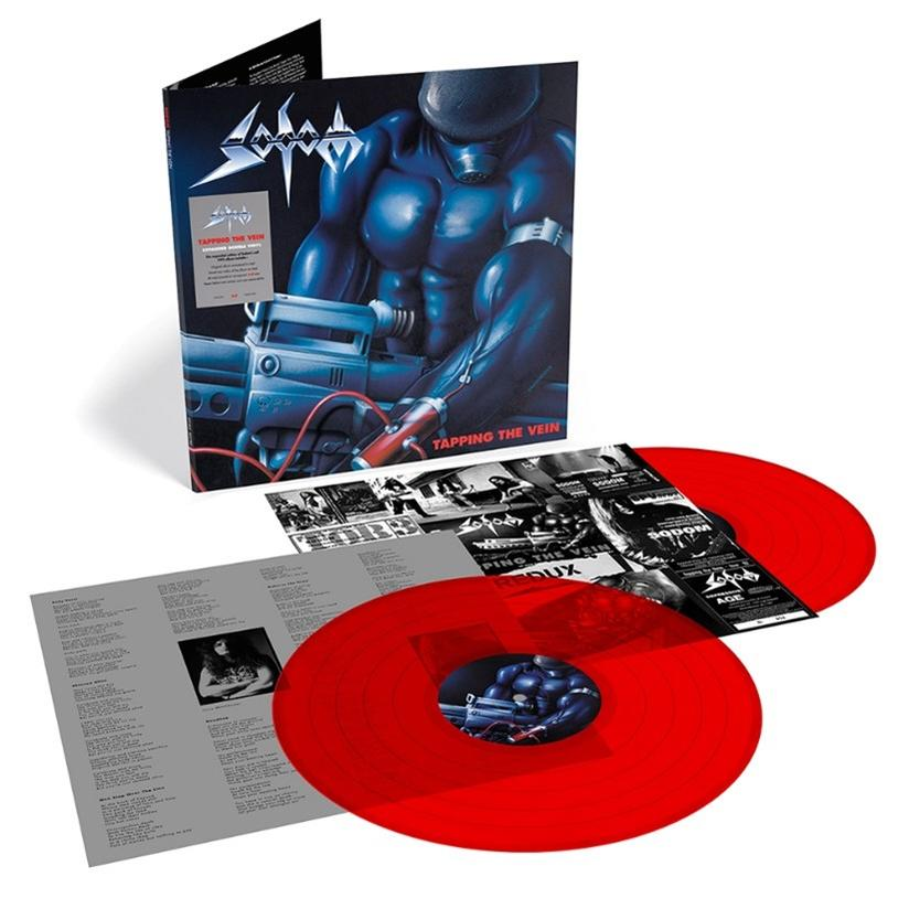 Rotes Vinyl-Schallplatten-Albumcover mit muskulöser blauer Figur, die eine Waffe hält, mit Texten und Innenhüllen.