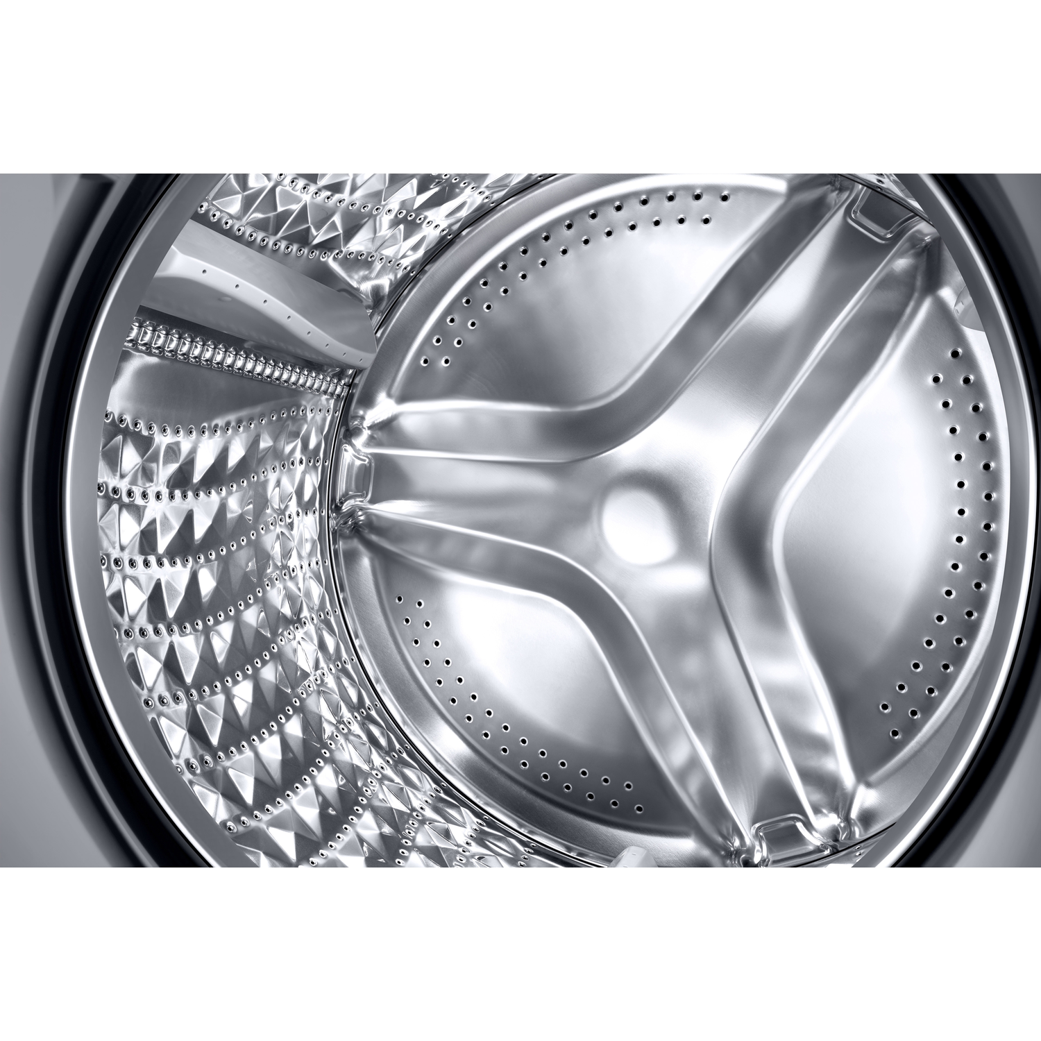 Close-up of a stainless steel washing machine drum with a central impeller.