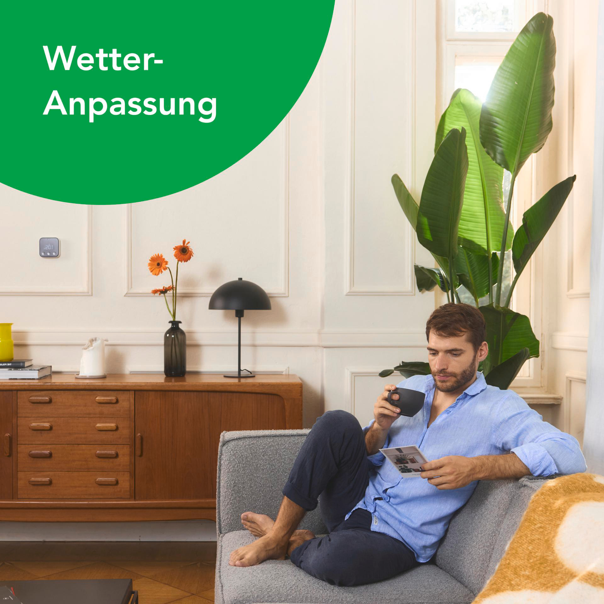 Ein schwarzes Thermostat an einer weißen Wand. Das Thermostat zeigt Temperatur und Steuerung.