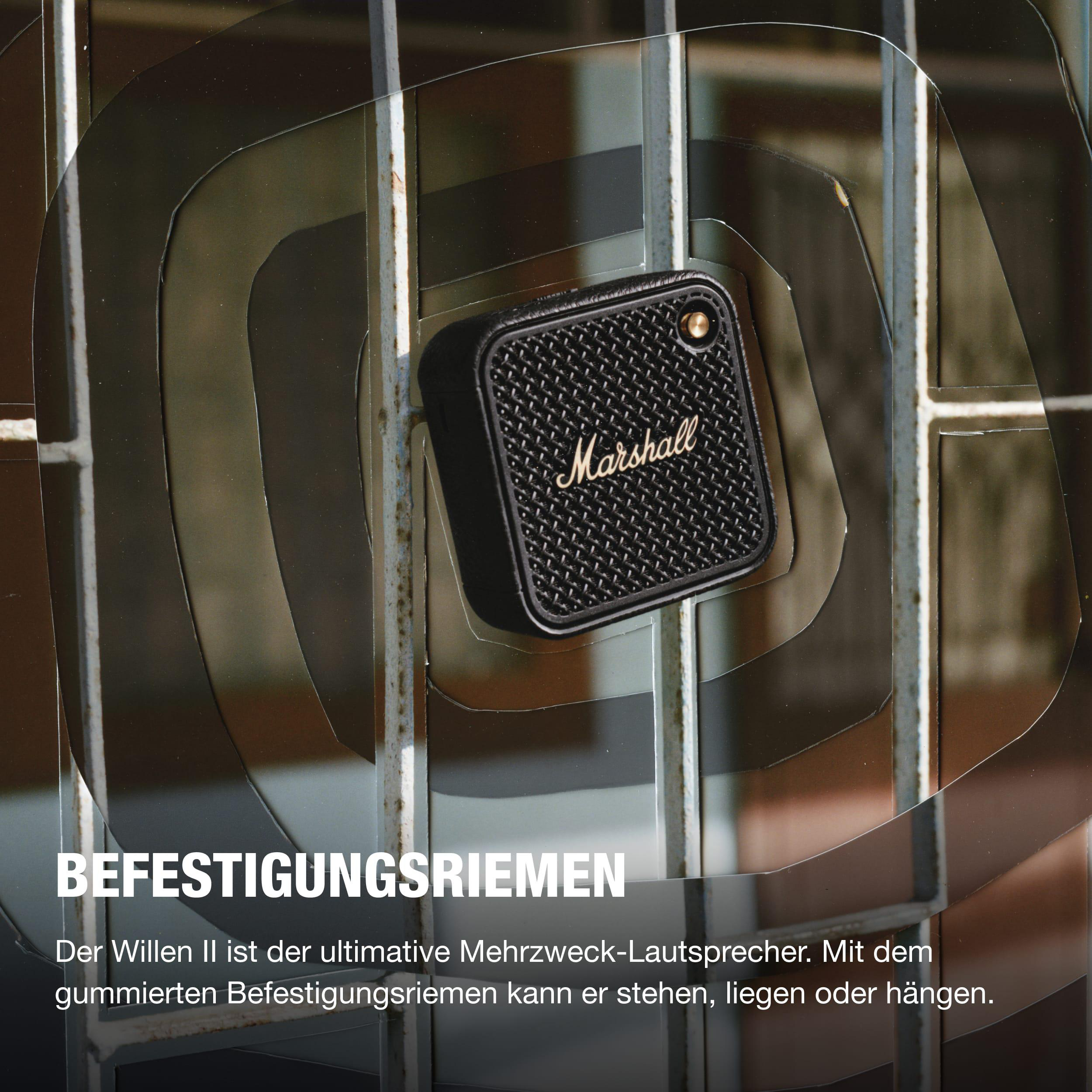 Ein kleiner schwarzer Marshall-Lautsprecher steht hinter einem Metalltor mit konzentrischen Lichtkreisen.