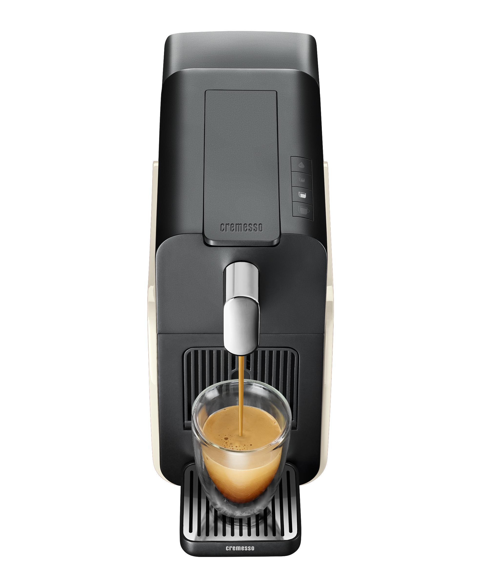 Eine Kaffeemaschine mit einem Glas Kaffee, auf der Maschine steht das Wort 'cremesso'.
