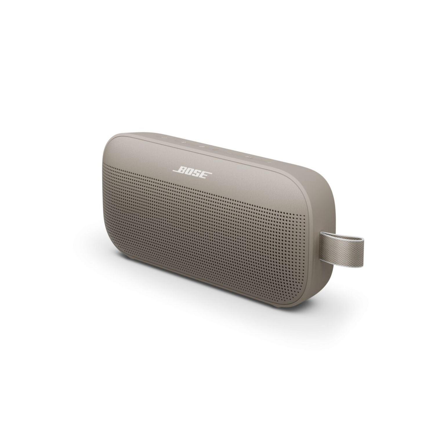 A beige portable speaker with a fabric loop handle is on a white surface.