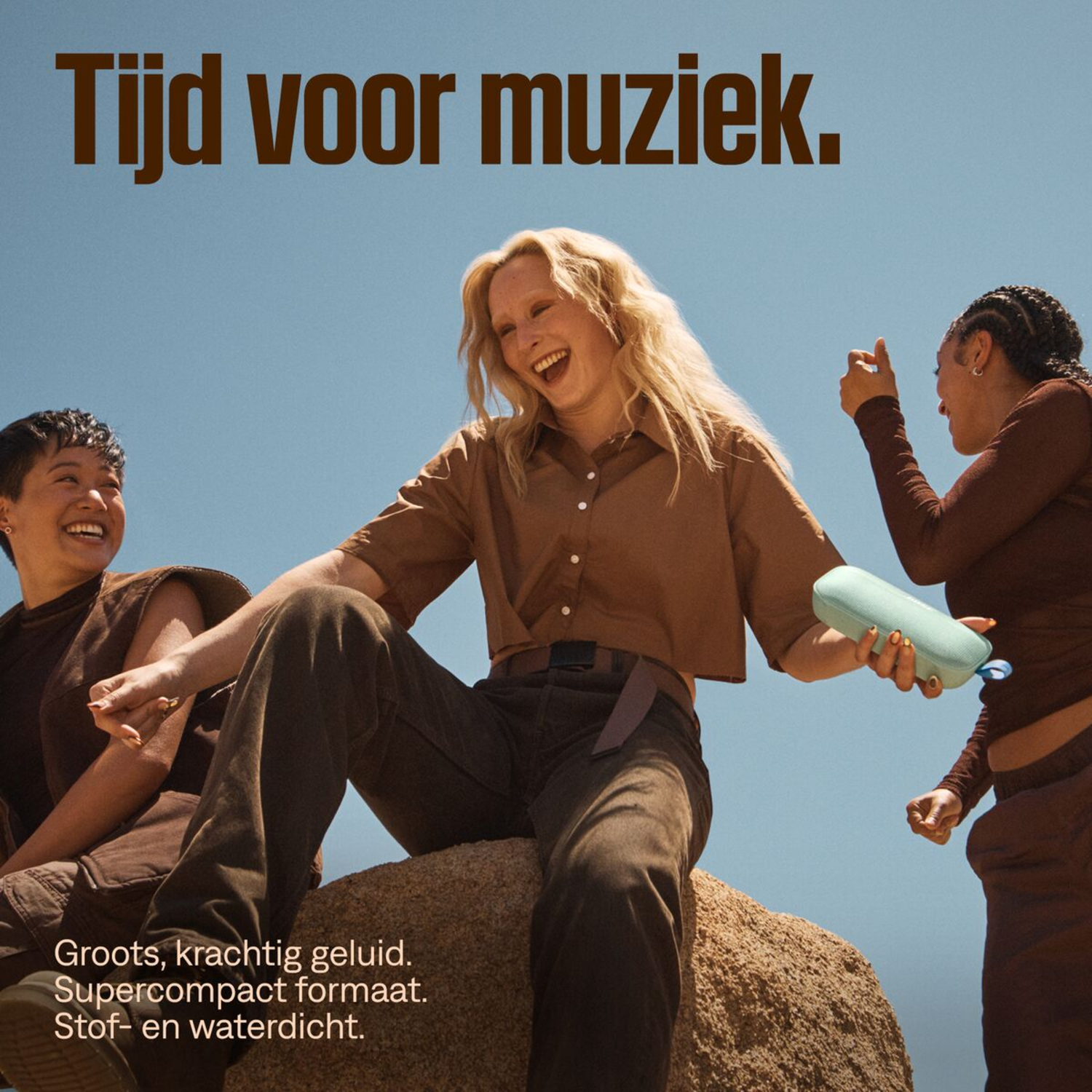 Three people with a speaker. Text: Time for music. Woman holding speaker, smiling and happy.