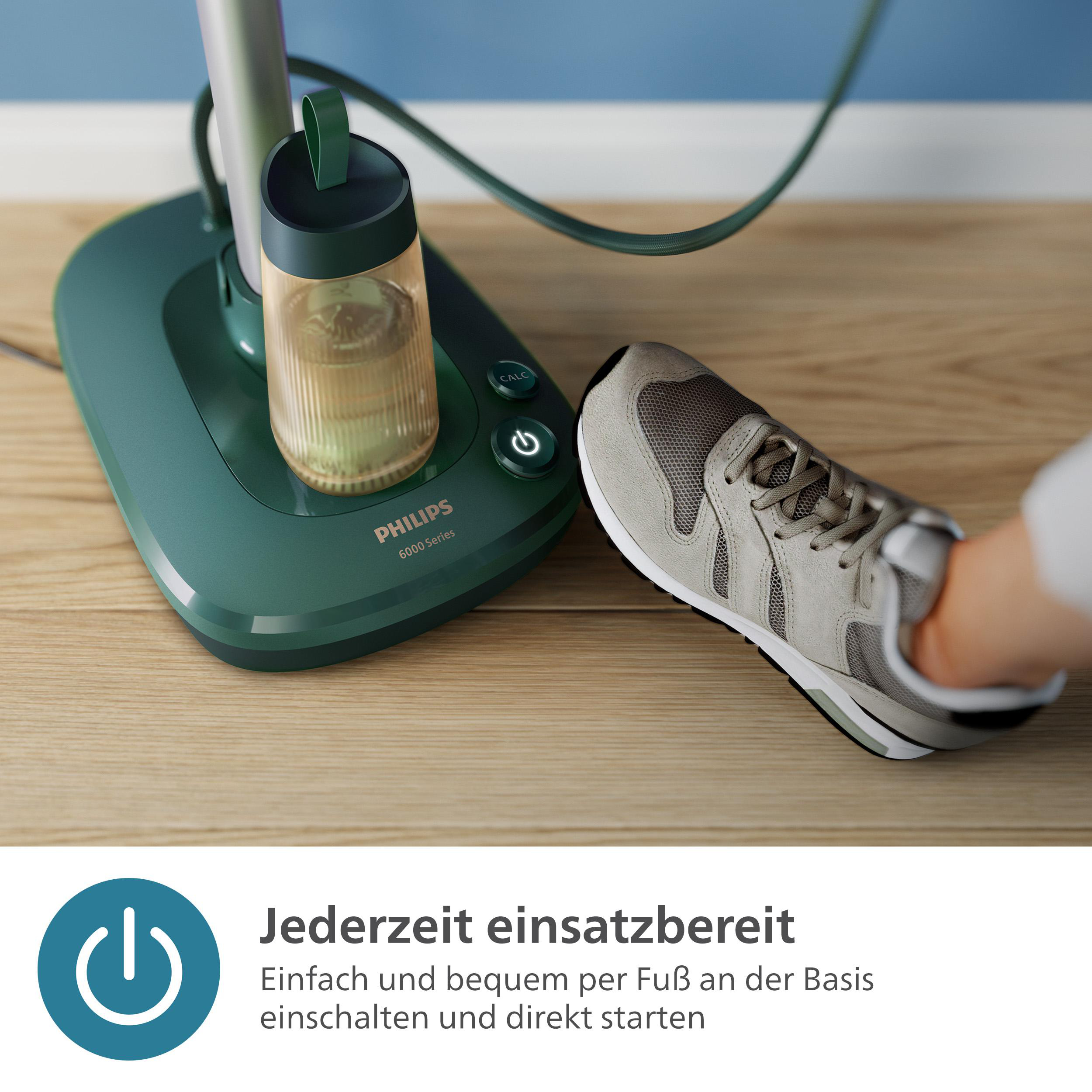 Grüne Basis mit dem Philips 6000er Serienlogo. Ein Turnschuh liegt auf dem Boden.